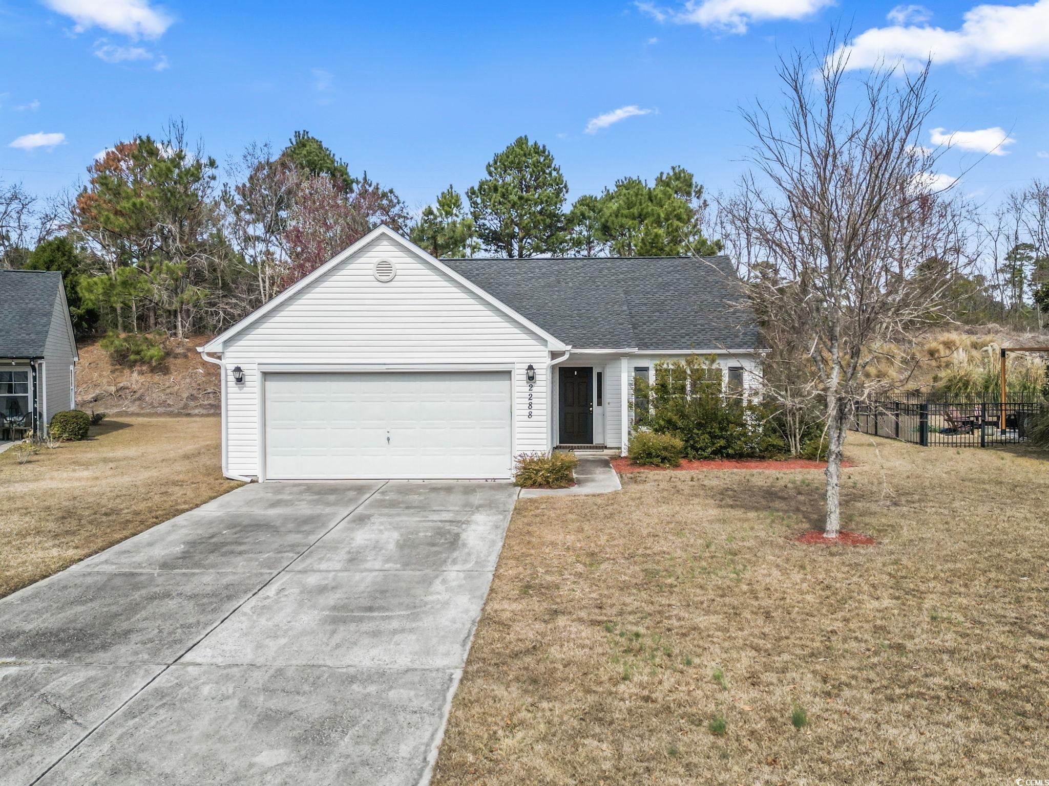 2288 Beauclair Court Myrtle Beach, SC 29579 - Photo 1 of 40 Ranch-style home featuring an attached garage, fence, concrete driveway, and a front yard