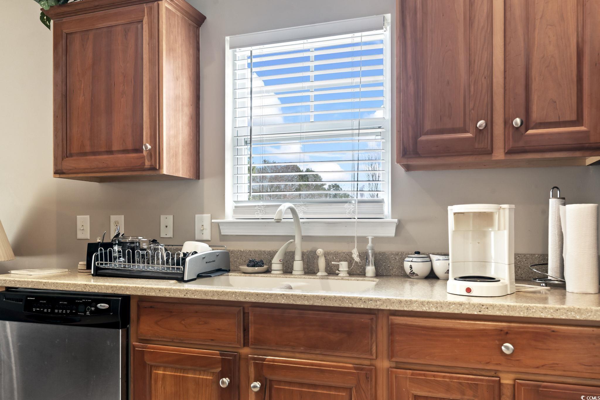 2288 Beauclair Court Myrtle Beach, SC 29579 - Photo 11 of 40 Kitchen featuring dishwasher, brown cabinetry, and a sink