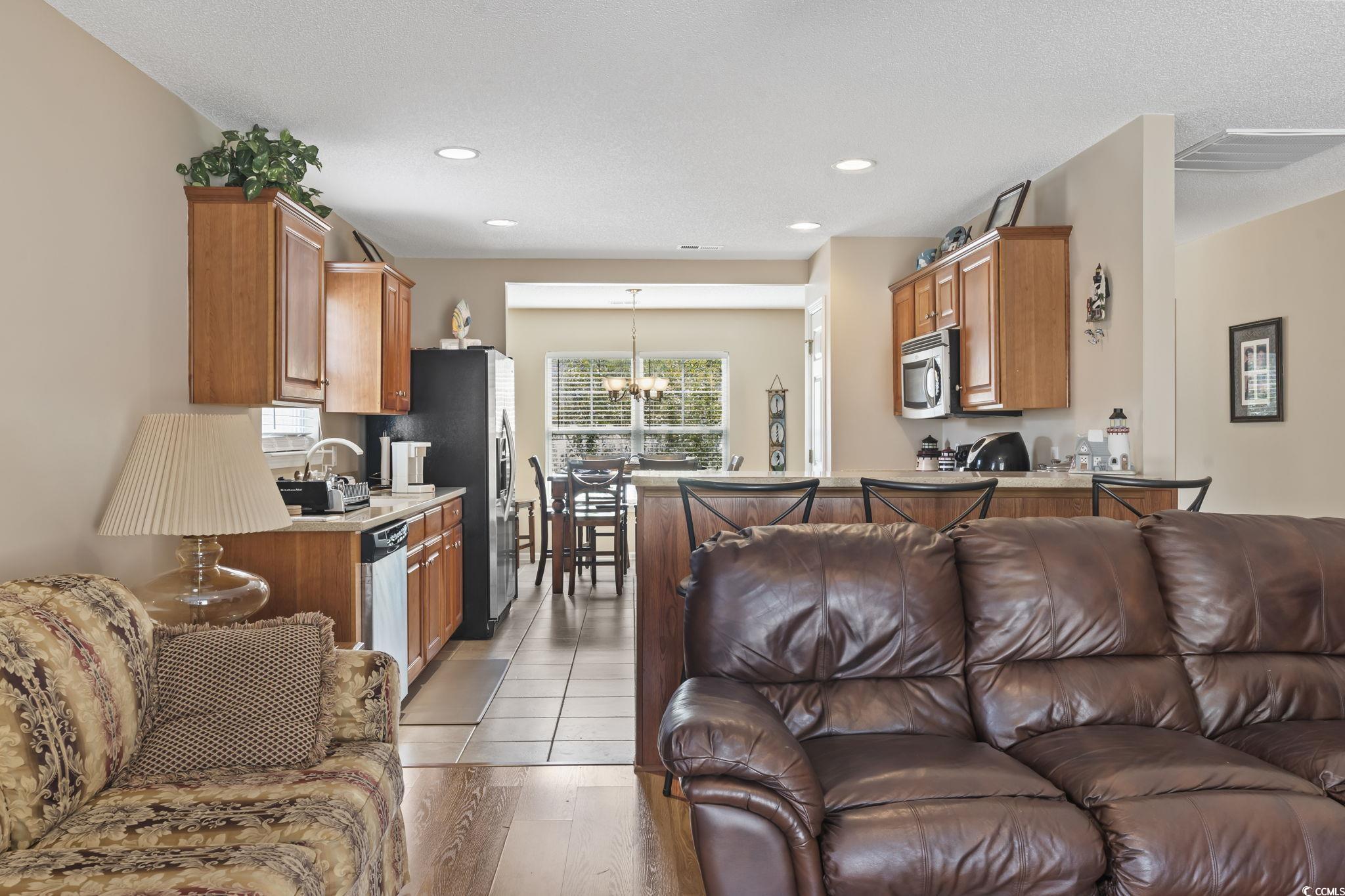 2288 Beauclair Court Myrtle Beach, SC 29579 - Photo 13 of 40 Living area featuring light wood finished floors, recessed lighting, and an inviting chandelier
