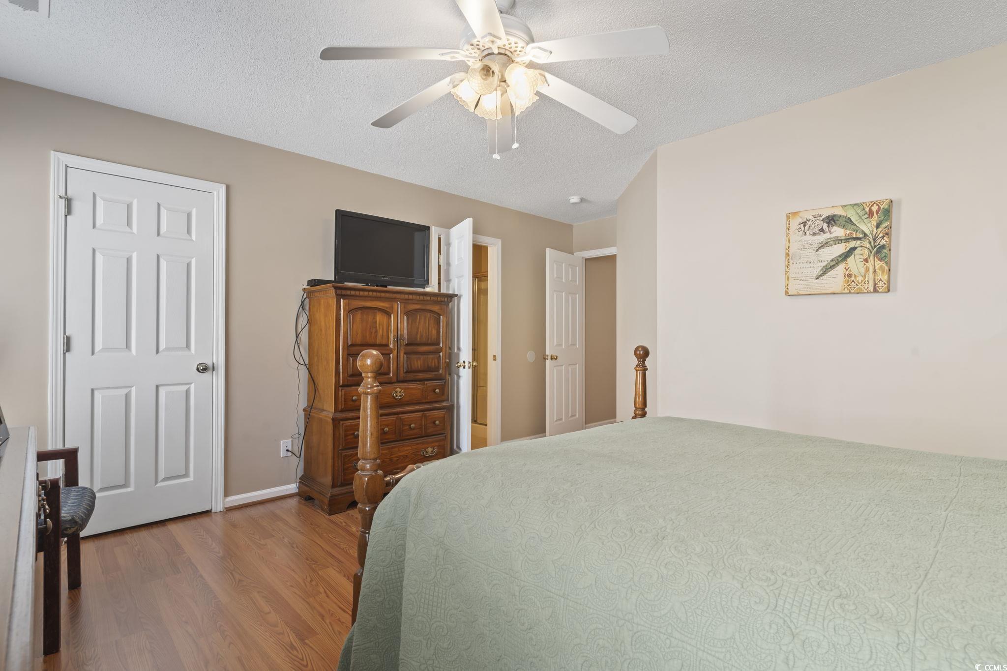 2288 Beauclair Court Myrtle Beach, SC 29579 - Photo 19 of 40 Bedroom featuring ceiling fan, a textured ceiling, baseboards, and wood finished floors