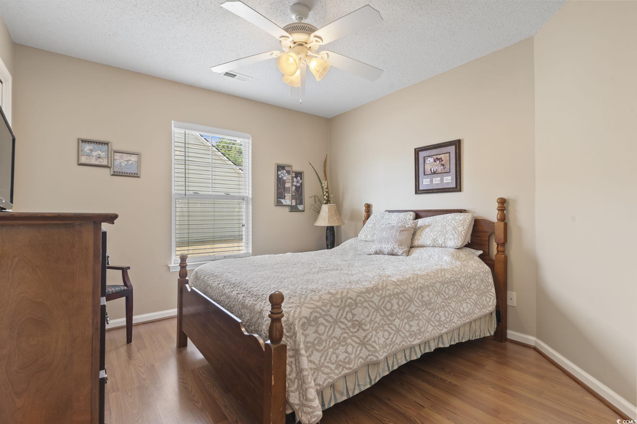 2288 Beauclair Court Myrtle Beach, SC 29579 - Photo 22 of 40 Bedroom featuring a textured ceiling, baseboards, and wood finished floors