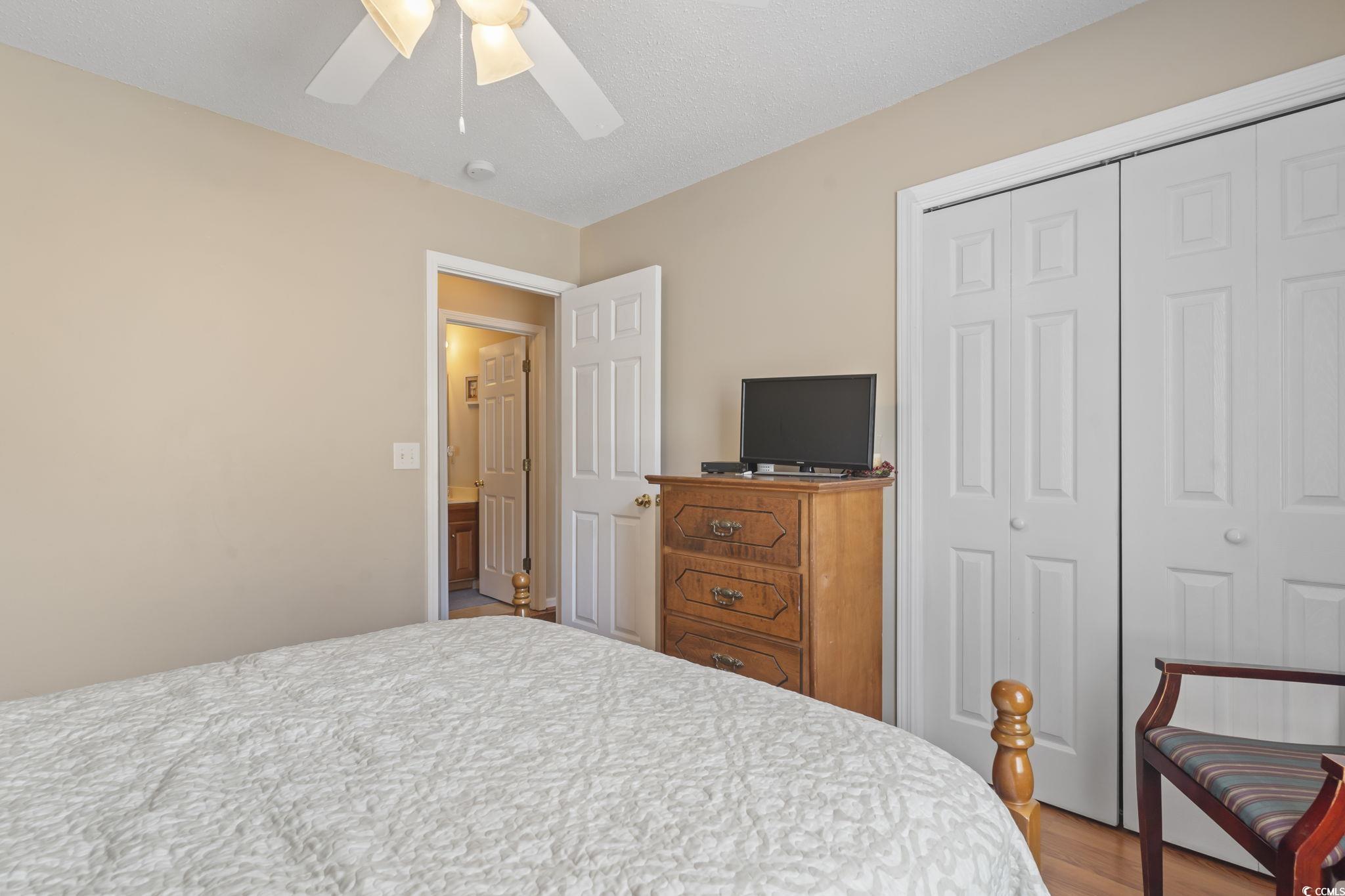 2288 Beauclair Court Myrtle Beach, SC 29579 - Photo 23 of 40 Bedroom featuring ceiling fan, a closet, and wood finished floors