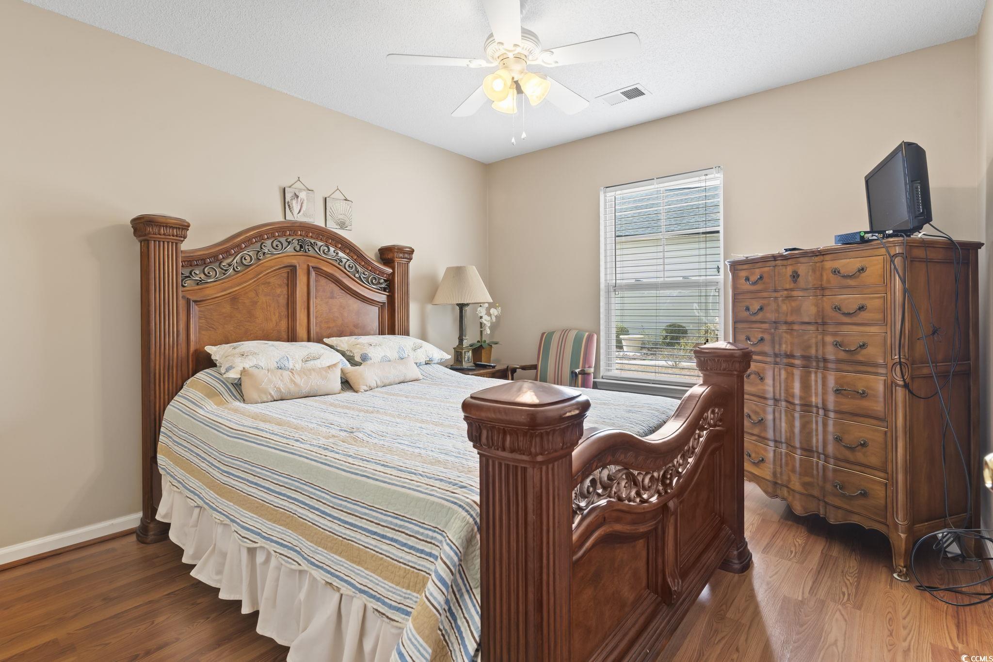 2288 Beauclair Court Myrtle Beach, SC 29579 - Photo 25 of 40 Bedroom featuring baseboards, visible vents, ceiling fan, and wood finished floors