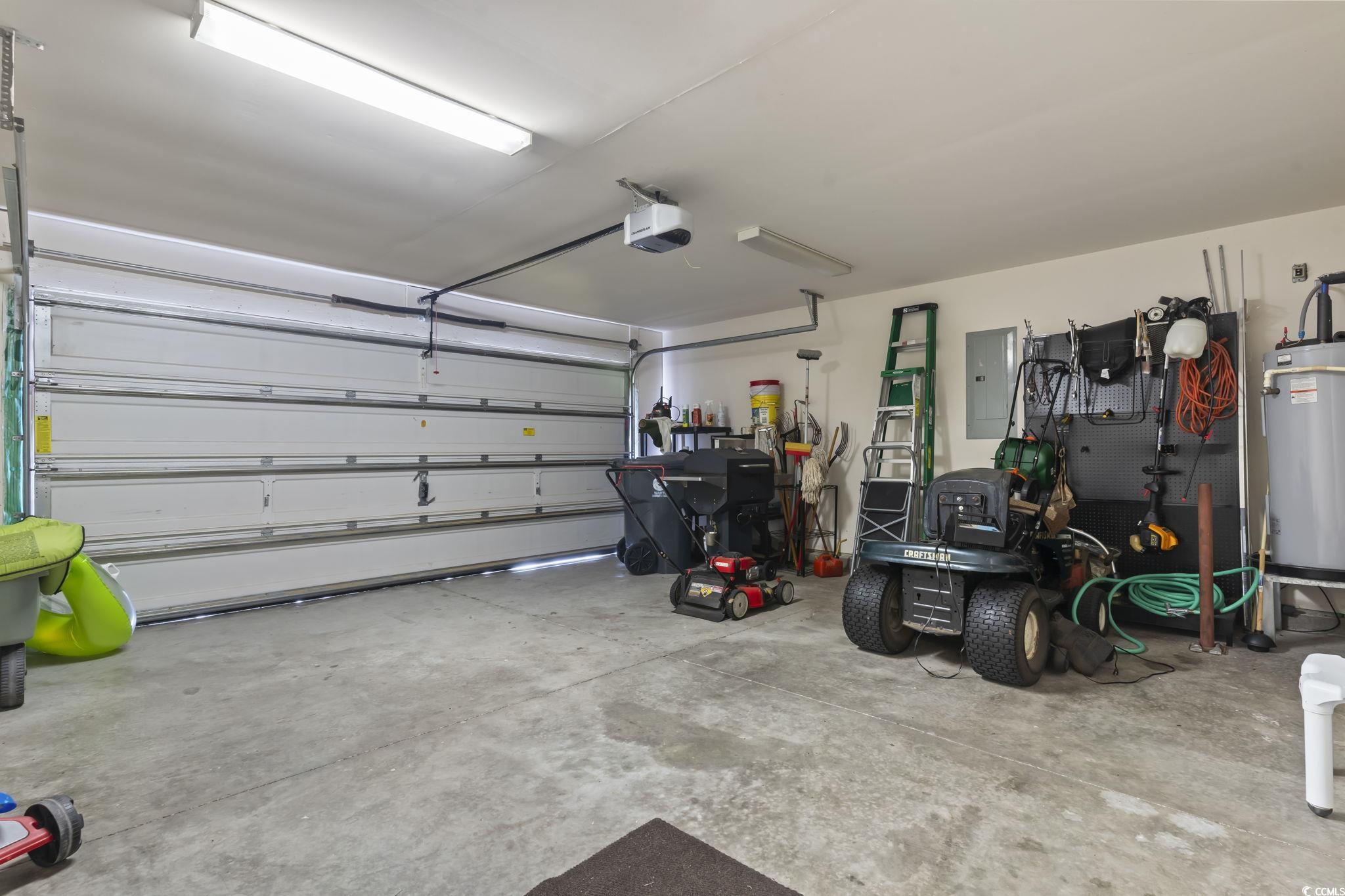 2288 Beauclair Court Myrtle Beach, SC 29579 - Photo 28 of 40 Garage with gas water heater, electric panel, and a garage door opener