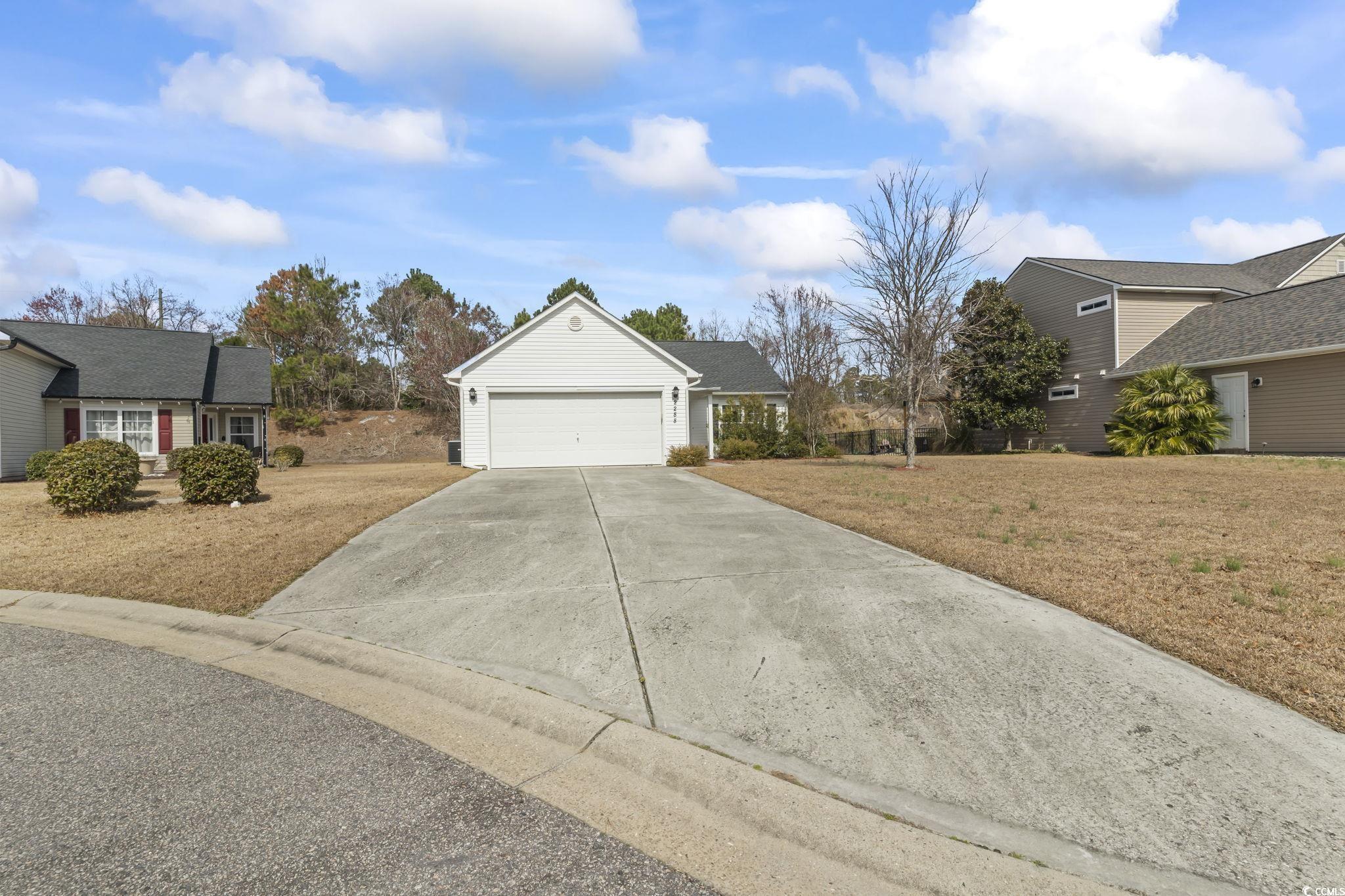 2288 Beauclair Court Myrtle Beach, SC 29579 - Photo 32 of 40 View of front of house with a garage, driveway, and a front lawn