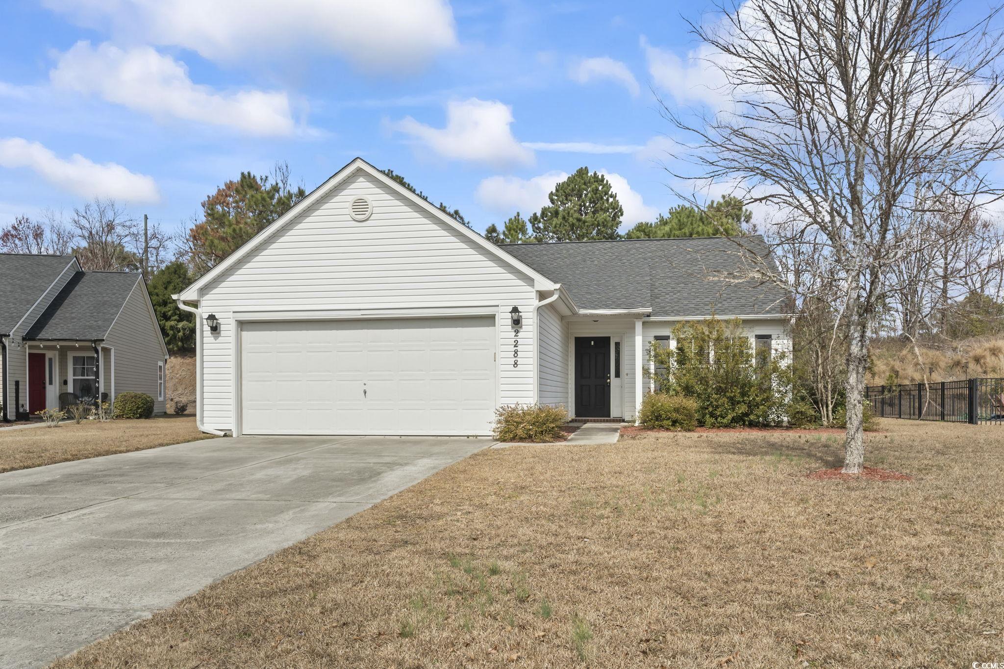 2288 Beauclair Court Myrtle Beach, SC 29579 - Photo 33 of 40 Ranch-style home with driveway, a garage, a shingled roof, fence, and a front yard