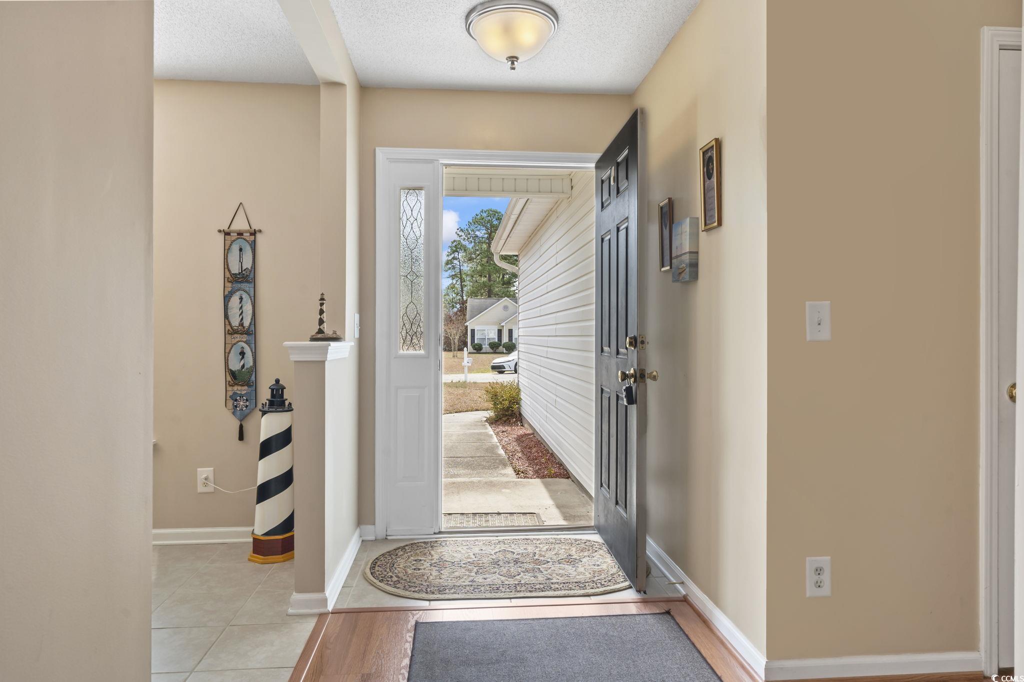 2288 Beauclair Court Myrtle Beach, SC 29579 - Photo 4 of 40 Entrance foyer featuring light tile patterned floors, baseboards, and a textured ceiling