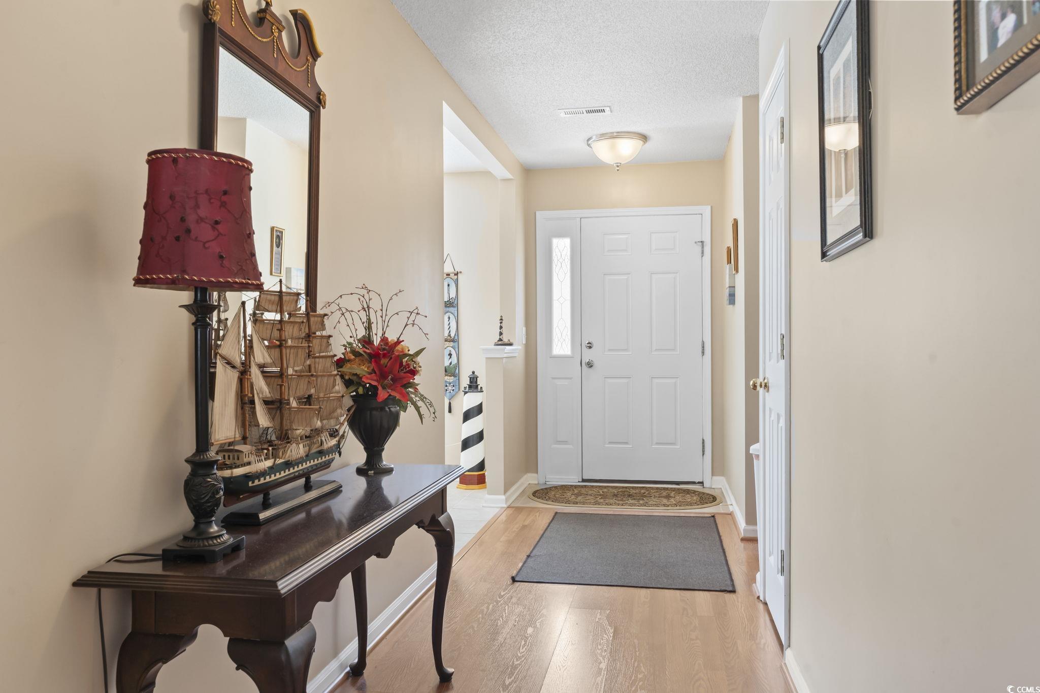 2288 Beauclair Court Myrtle Beach, SC 29579 - Photo 5 of 40 Foyer with light wood-style floors, baseboards, visible vents, and a textured ceiling