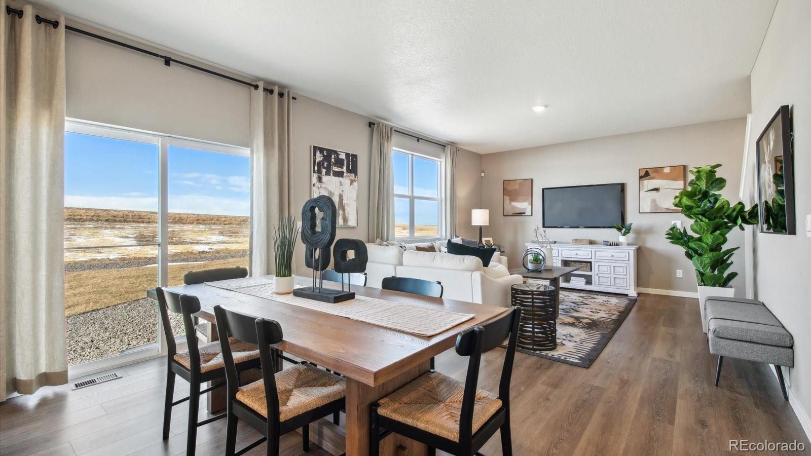 2202 Base Street Fort Lupton, CO 80621 - Photo 13 of 24 a view of a dining room with furniture window and wooden floor