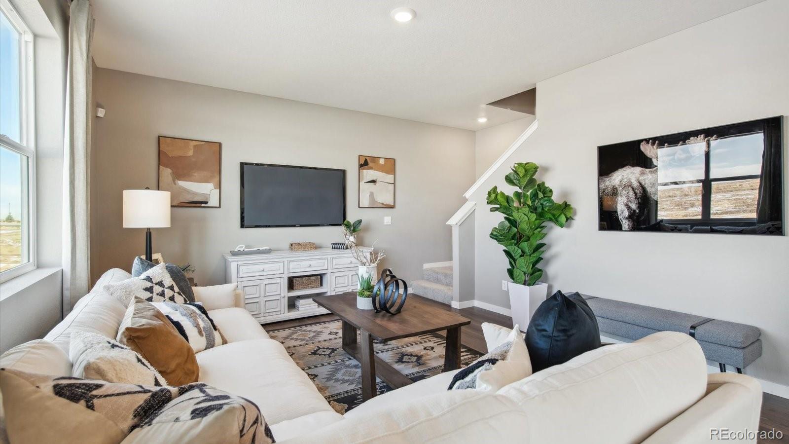 2202 Base Street Fort Lupton, CO 80621 - Photo 2 of 24 a living room with furniture and a flat screen tv
