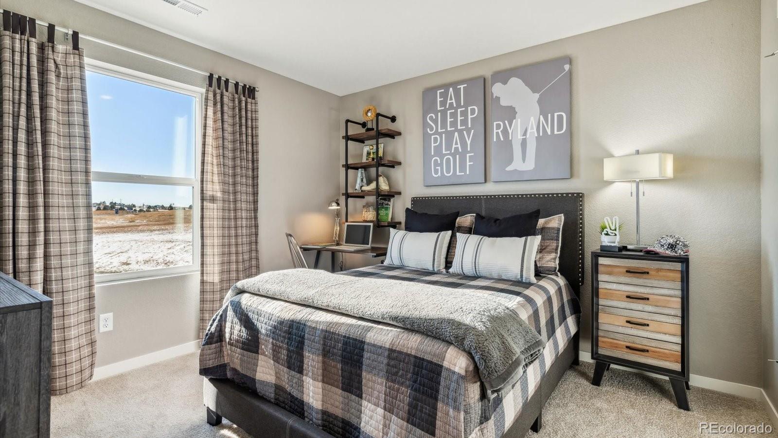 2202 Base Street Fort Lupton, CO 80621 - Photo 21 of 24 a bedroom with a bed a lamp and a large window