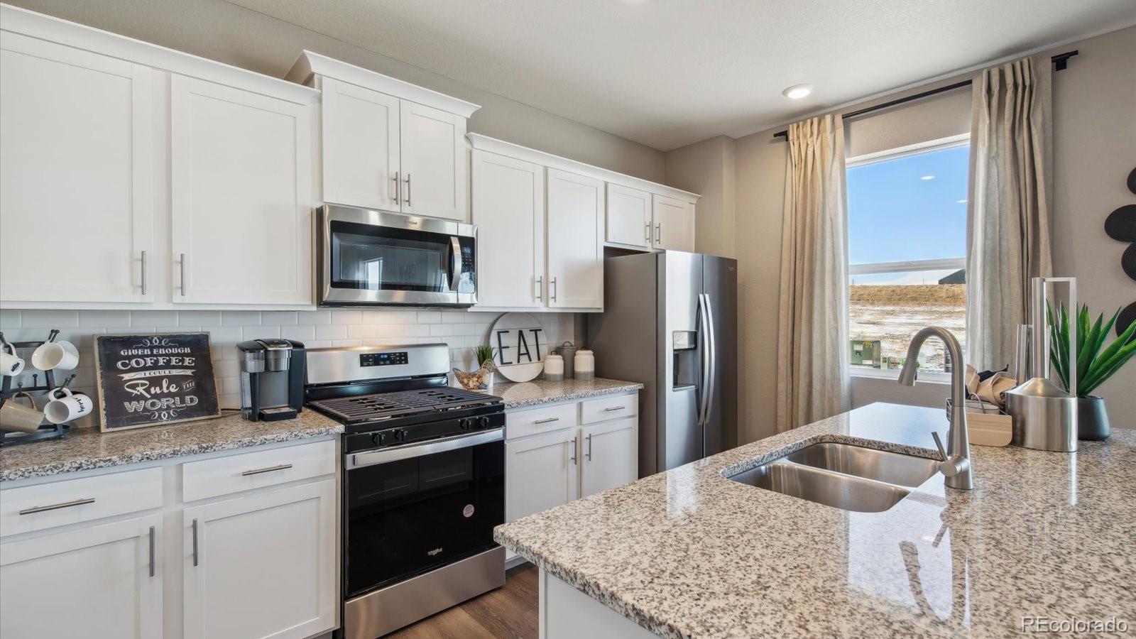 2202 Base Street Fort Lupton, CO 80621 - Photo 8 of 24 a kitchen with appliances a counter space and cabinets