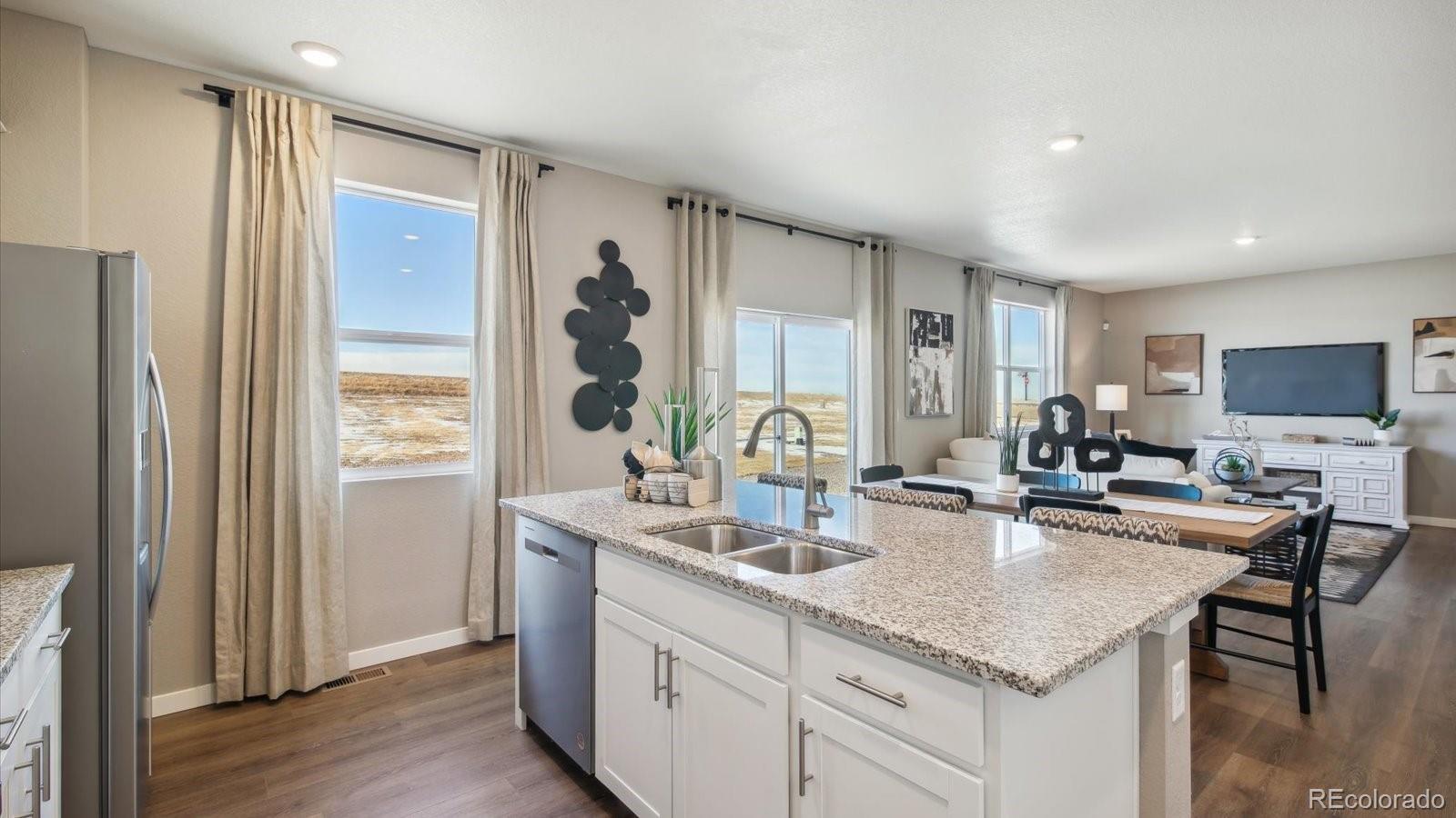 2202 Base Street Fort Lupton, CO 80621 - Photo 9 of 24 a kitchen with granite countertop a sink and cabinets