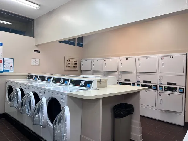 a kitchen with a white stove top oven sink and white cabinets