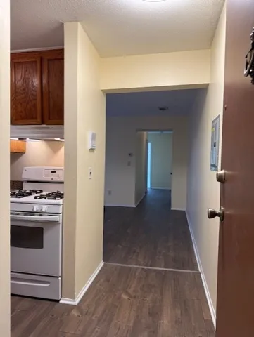 a view of a kitchen from a hallway