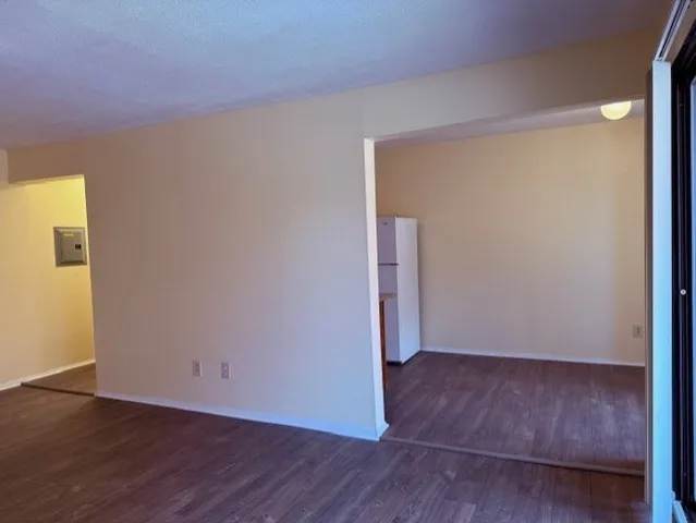 an empty room with wooden floor and closet