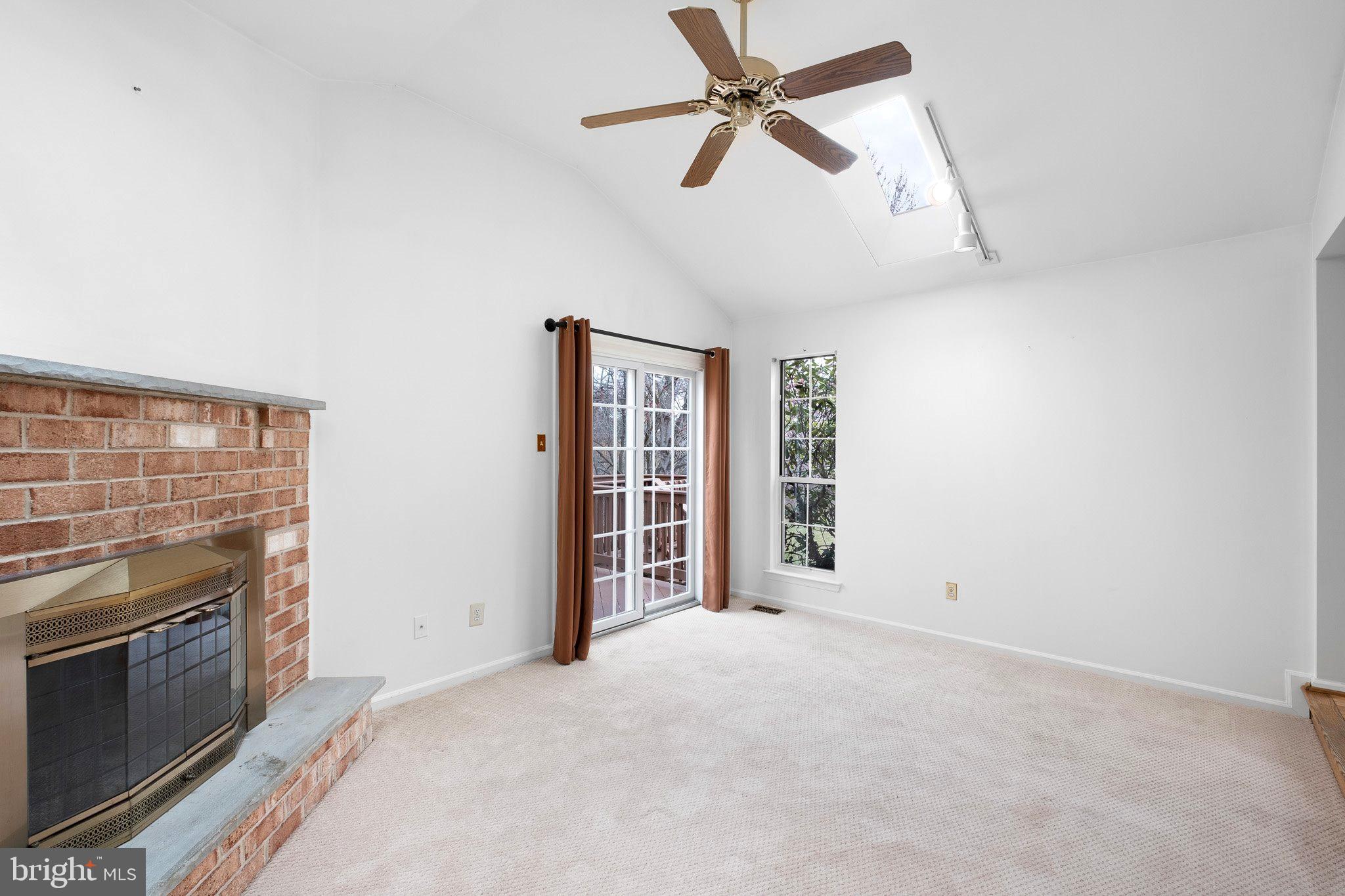 163 Cambridge Circle, Unit 78 Kennett Square, PA 19348 - Photo 13 of 30 a view of a kitchen with a stove cabinets a ceiling fan and wooden floor