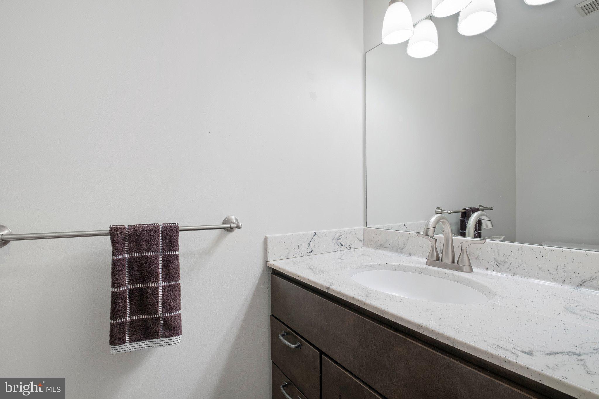 163 Cambridge Circle, Unit 78 Kennett Square, PA 19348 - Photo 16 of 30 a bathroom with a sink and a mirror