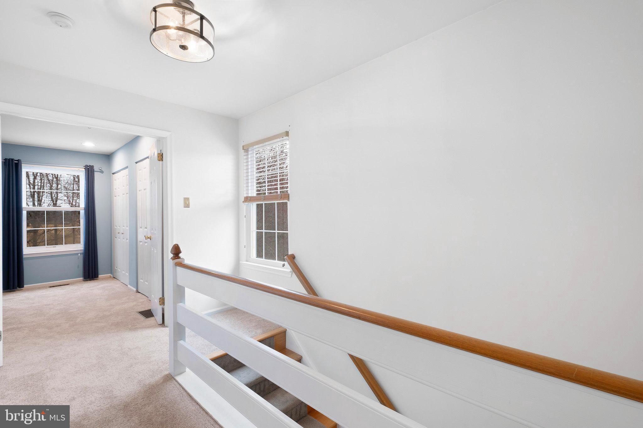 163 Cambridge Circle, Unit 78 Kennett Square, PA 19348 - Photo 18 of 30 a view of a hallway with a white walls and a large window