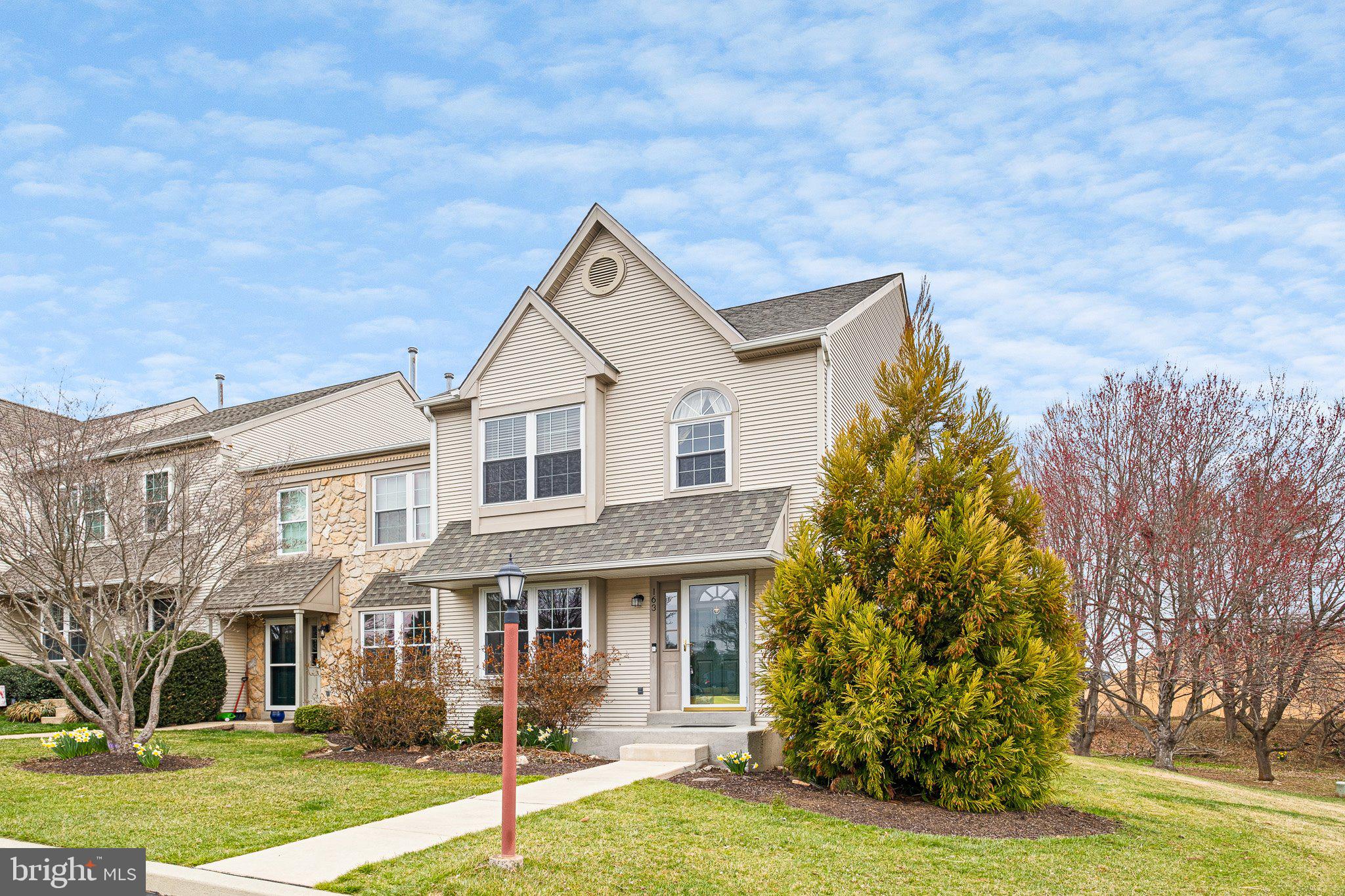 163 Cambridge Circle, Unit 78 Kennett Square, PA 19348 - Photo 2 of 30 a view of a white house next to a yard with big trees