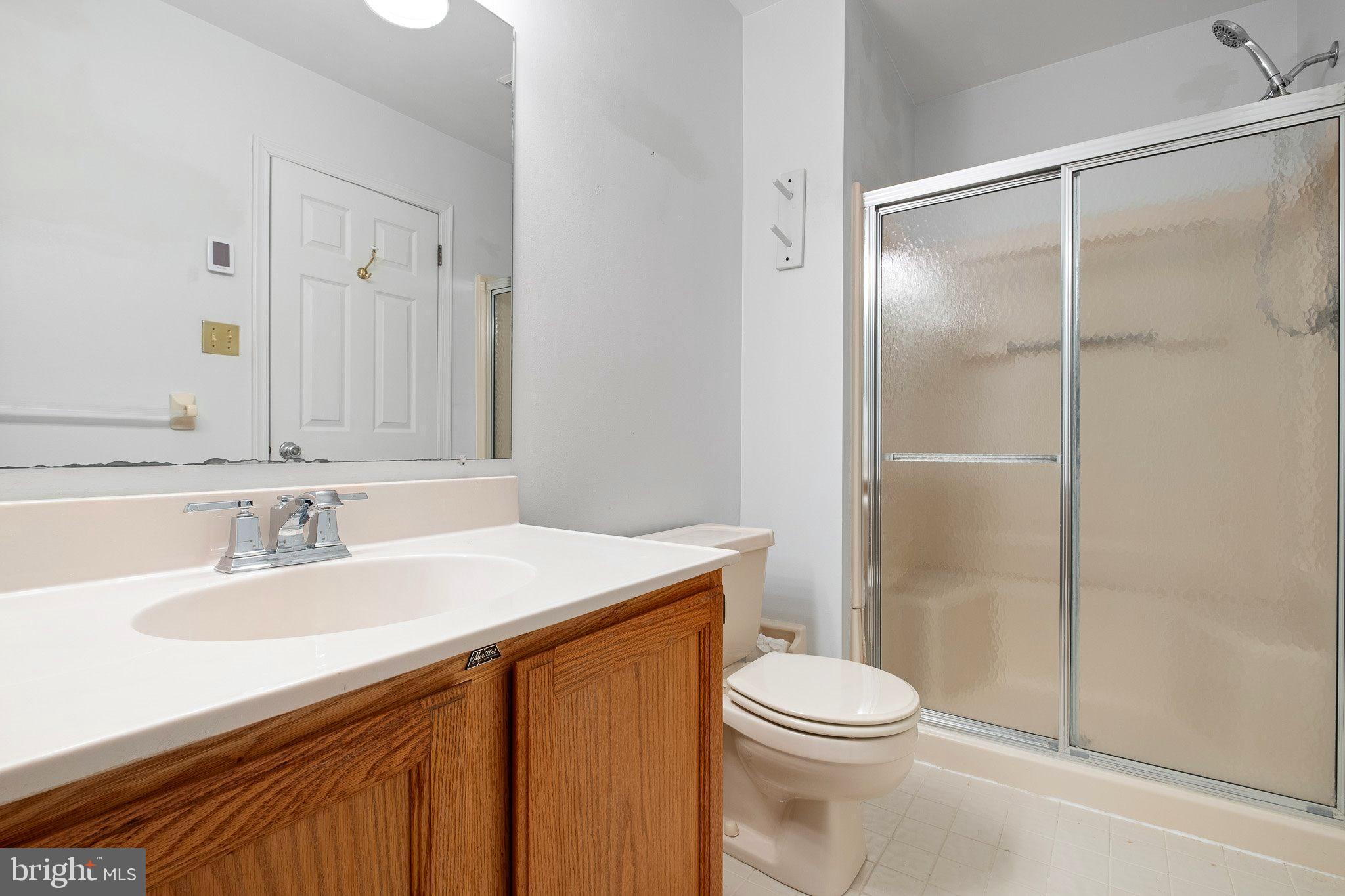 163 Cambridge Circle, Unit 78 Kennett Square, PA 19348 - Photo 21 of 30 a bathroom with a sink a toilet and shower