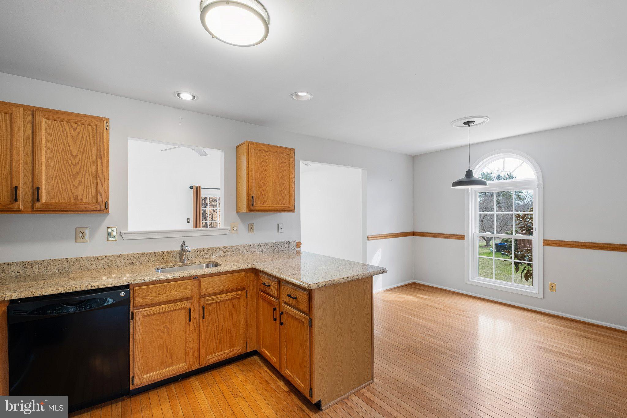 163 Cambridge Circle, Unit 78 Kennett Square, PA 19348 - Photo 9 of 30 a kitchen with wooden floors and sink