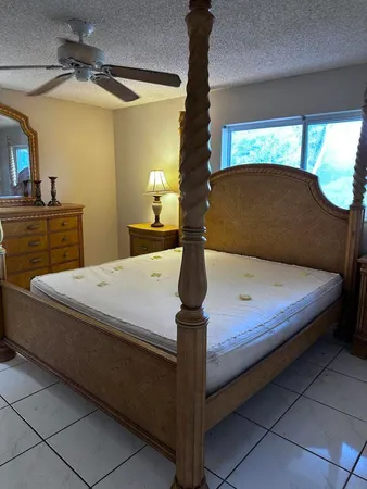 a bed sitting in a bedroom next to a window