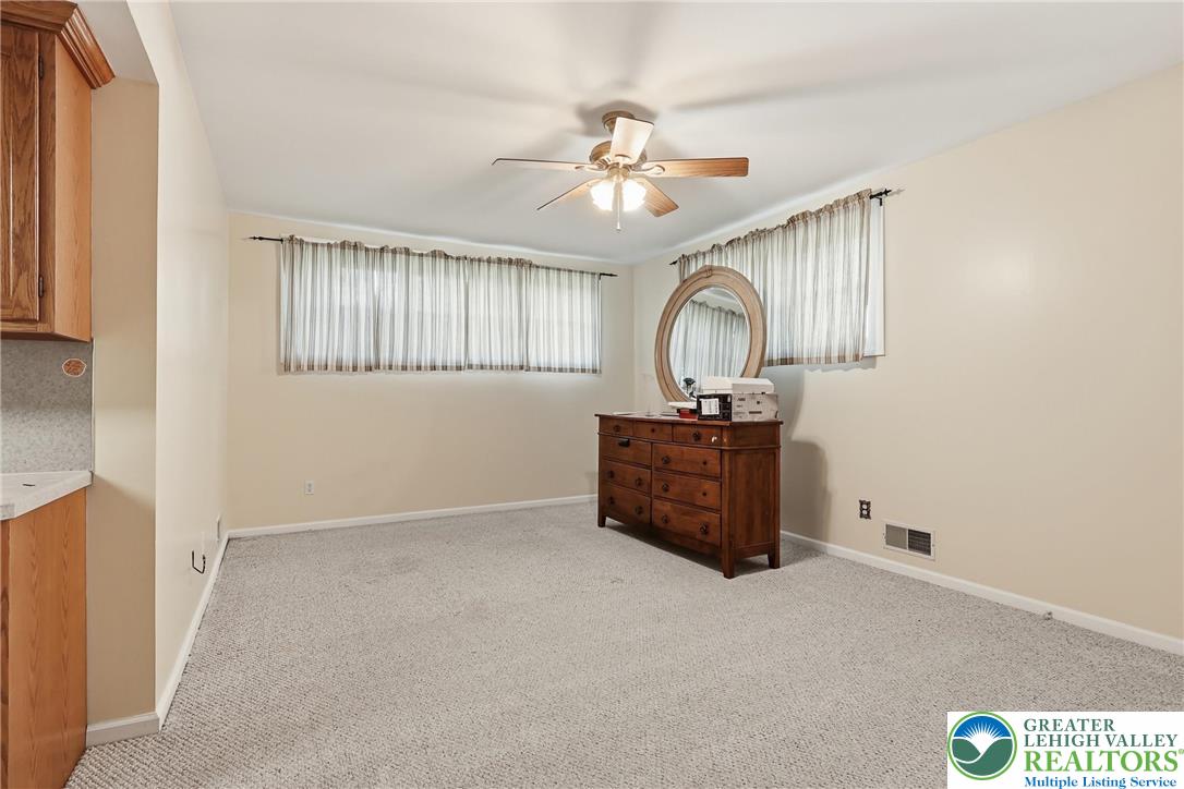 5217 Cider Press Road Schnecksville, PA 18078 - Photo 42 of 54 an empty room with a ceiling fan and a window