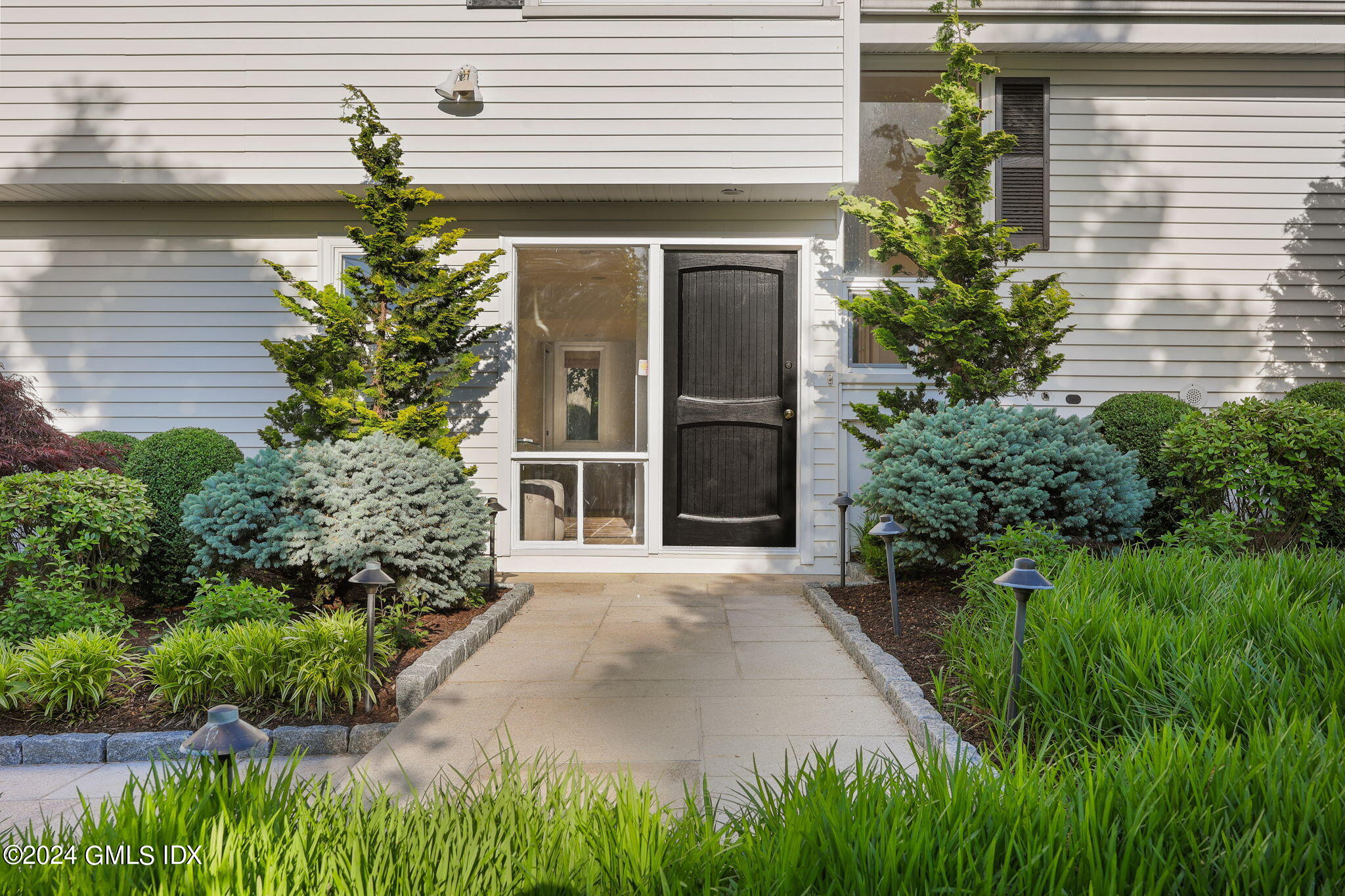18 Crawford Terrace Riverside, CT 06878 - Photo 2 of 31 a front view of a house with a garden