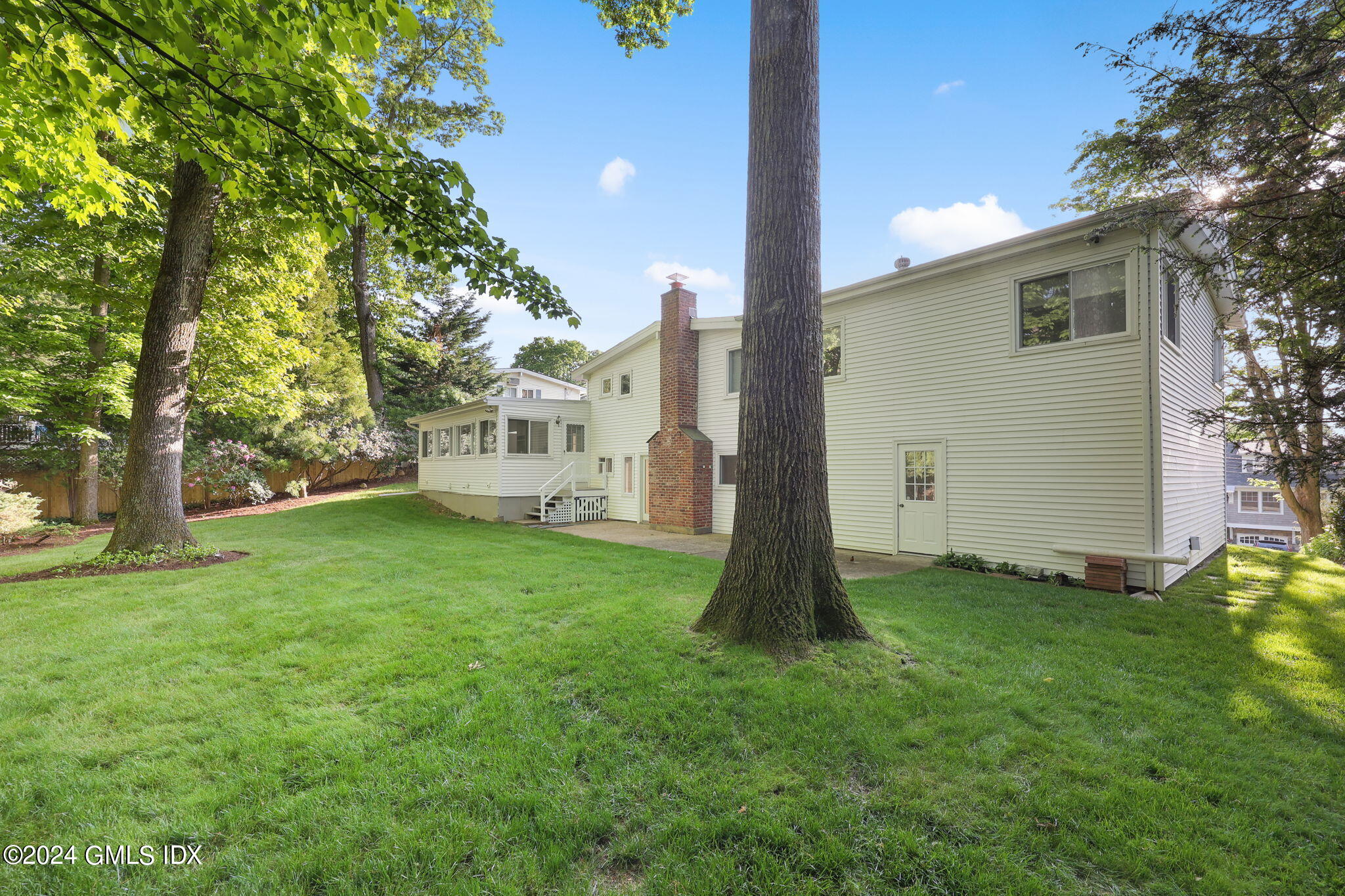 18 Crawford Terrace Riverside, CT 06878 - Photo 28 of 31 a view of a white house with a big yard and large tree
