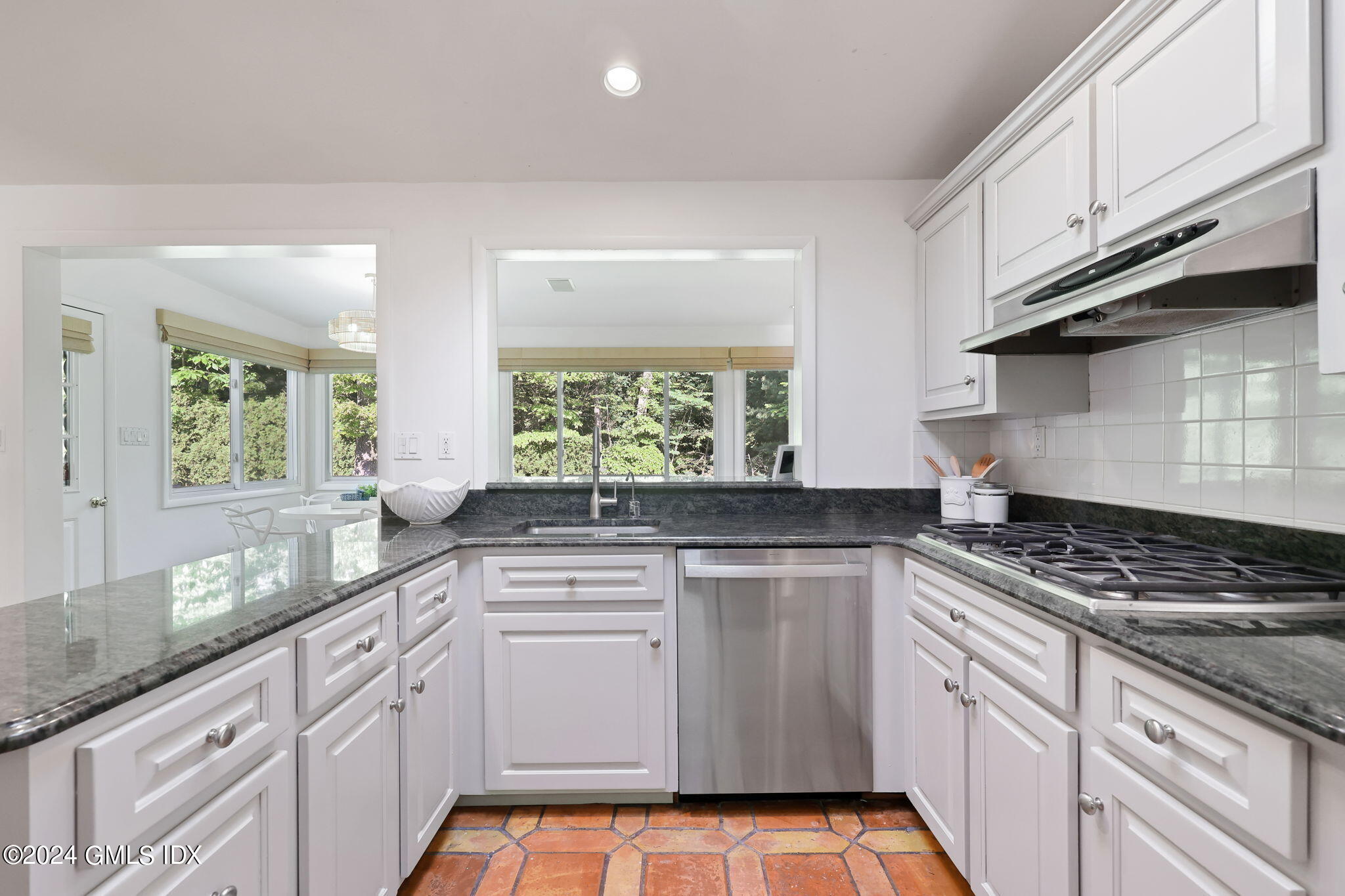 18 Crawford Terrace Riverside, CT 06878 - Photo 10 of 31 a kitchen with granite countertop white cabinets and white appliances