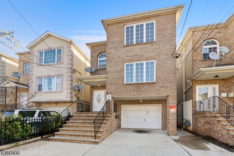 427 Fulton Street, Unit 2 Elizabeth Port, NJ 07206 - Photo 3 of 17 a front view of a house with a garage