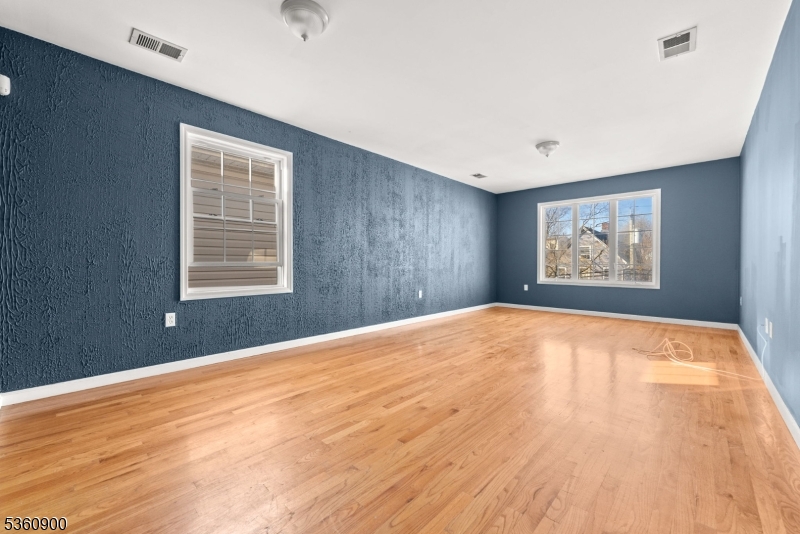 427 Fulton Street, Unit 2 Elizabeth Port, NJ 07206 - Photo 5 of 17 a view of an empty room with a window and wooden floor