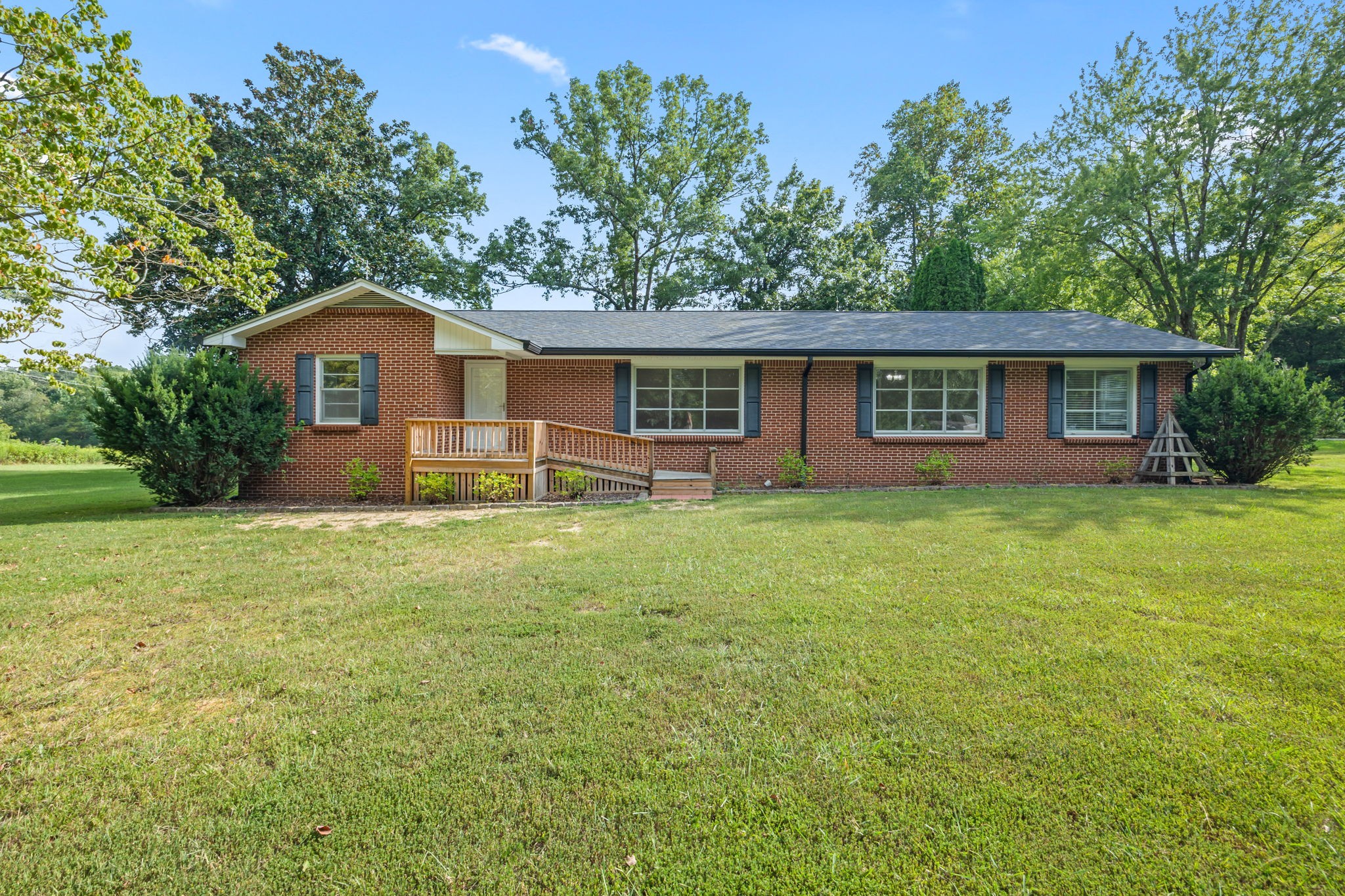 a front view of house with yard and green space