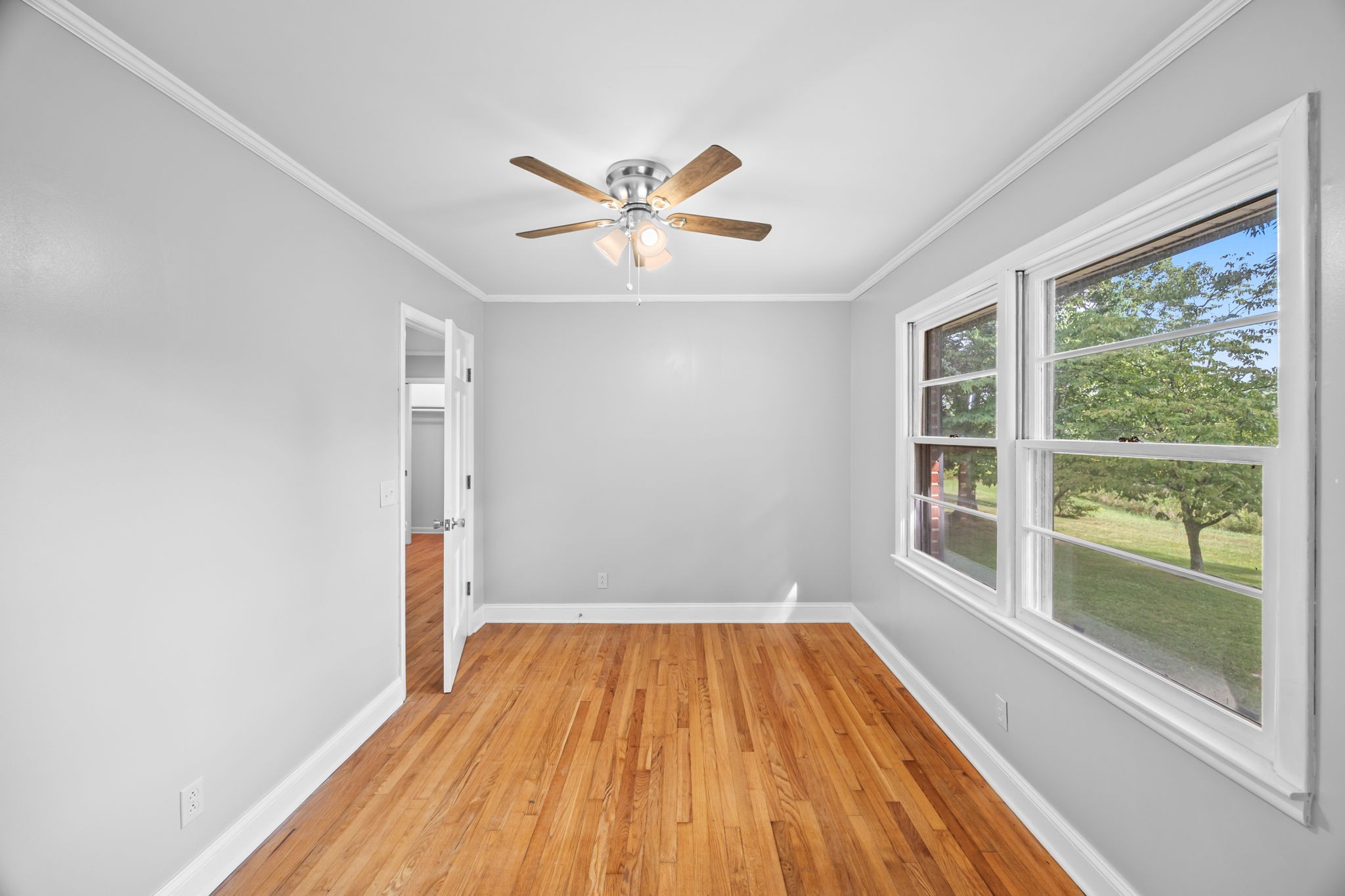 6510 Clemons Ridge Road Silver Point, TN 38582 - Photo 14 of 44 a view of a room with wooden floor and a ceiling fan