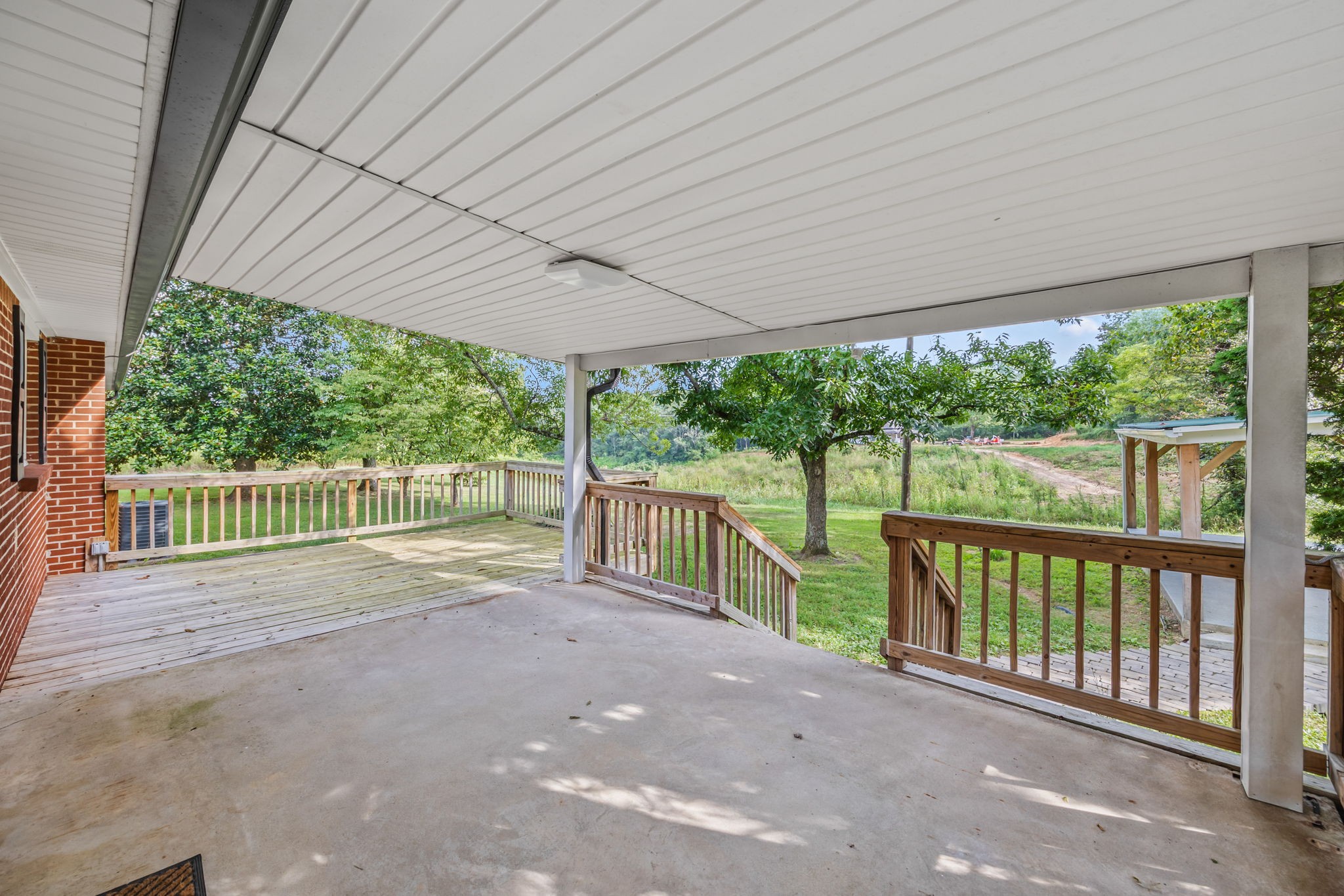 6510 Clemons Ridge Road Silver Point, TN 38582 - Photo 4 of 44 a view of a deck with wooden floor and roof with a floor to ceiling window