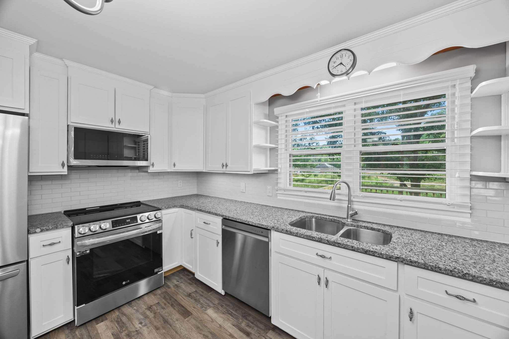 6510 Clemons Ridge Road Silver Point, TN 38582 - Photo 10 of 44 a kitchen with granite countertop a sink cabinets stainless steel appliances and a window