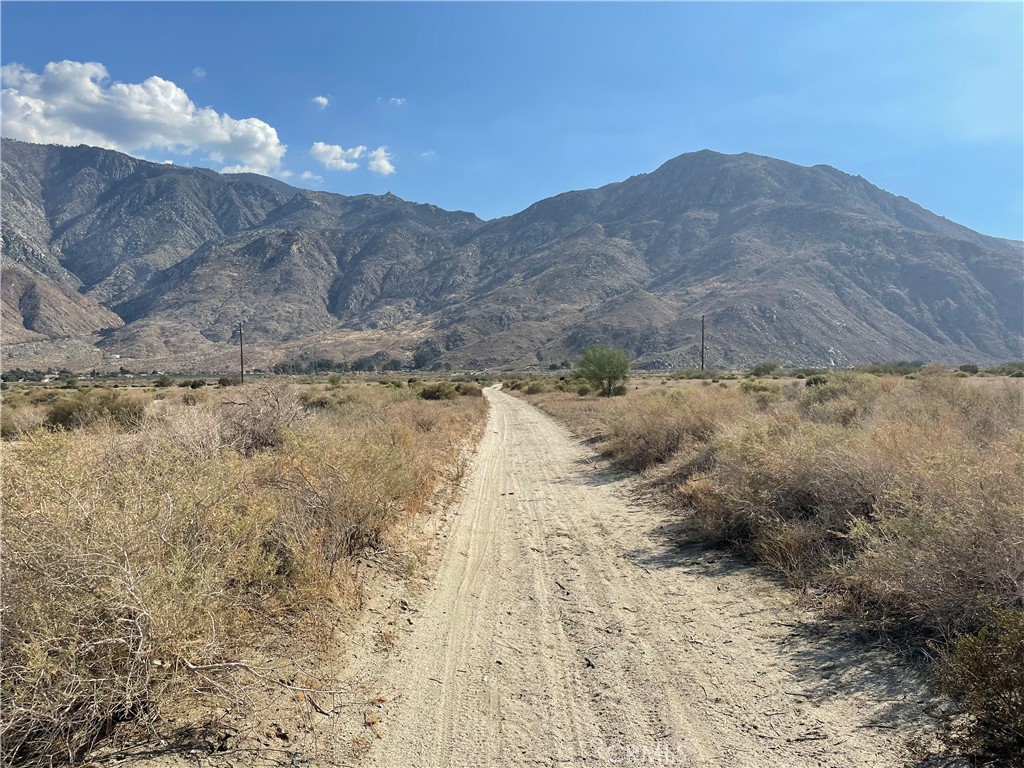 0 Olive Street Cabazon, CA 92230 - Photo 9 of 13 a view of a dry yard with mountains in the background