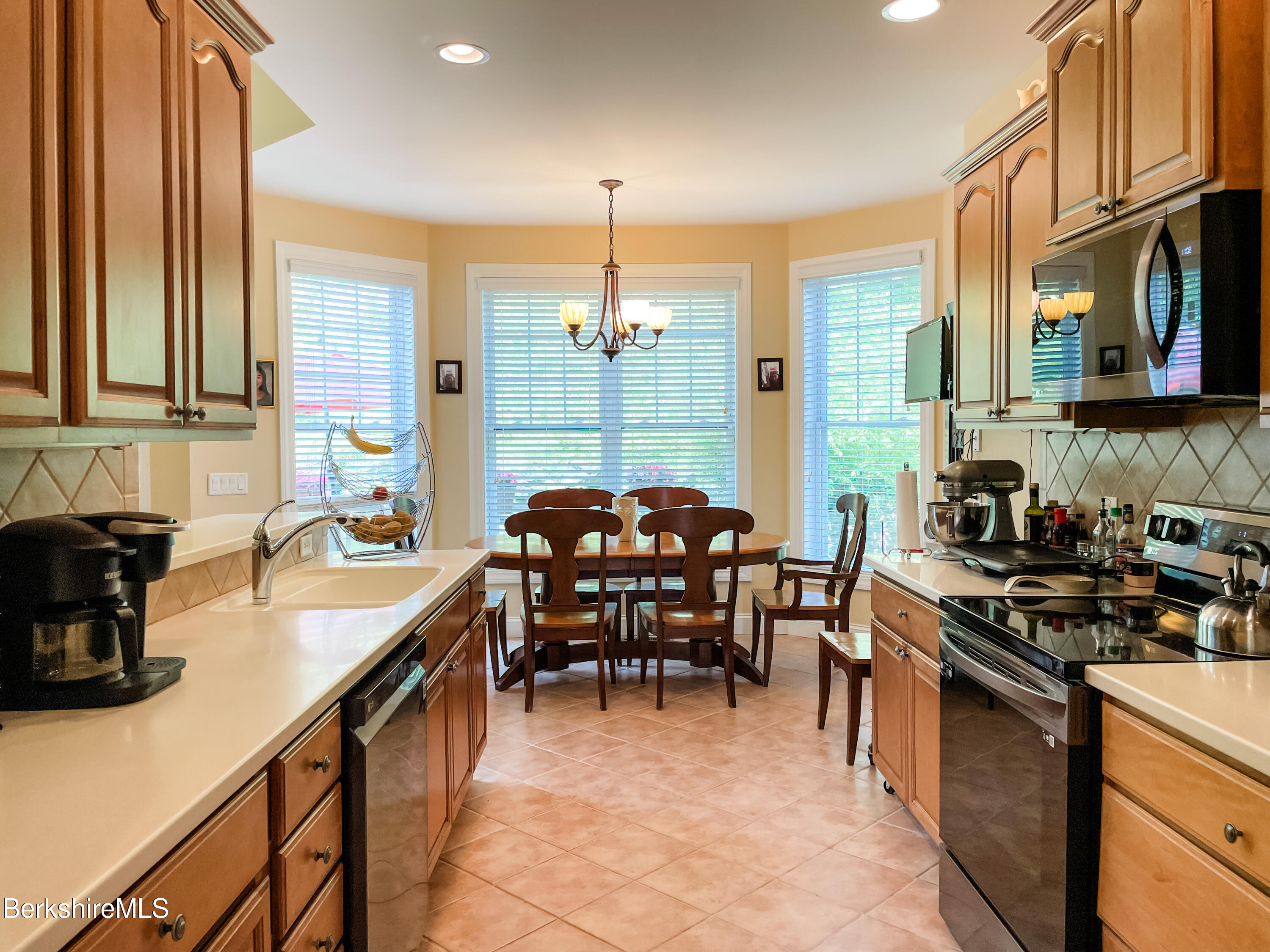 22 Alpine Trail Pittsfield, MA 01201 - Photo 11 of 35 a kitchen with granite countertop a sink stove and cabinets