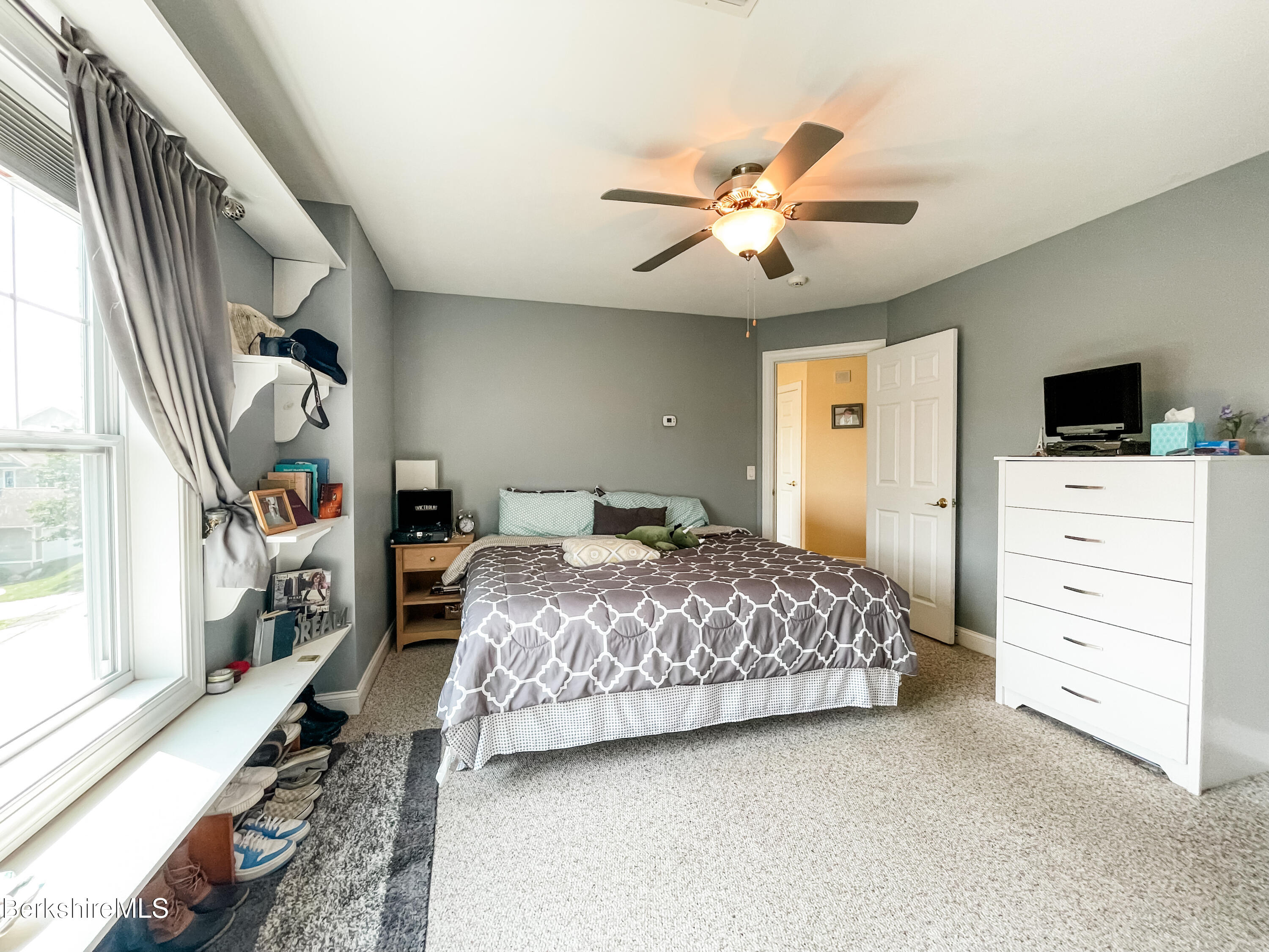 22 Alpine Trail Pittsfield, MA 01201 - Photo 19 of 35 a bedroom with a large bed and a chandelier