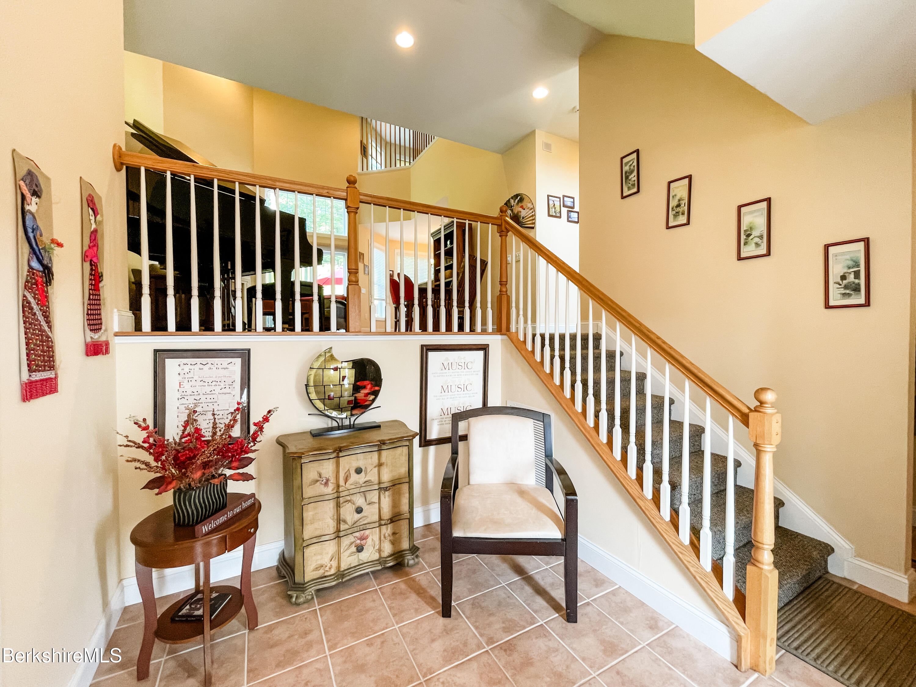 22 Alpine Trail Pittsfield, MA 01201 - Photo 6 of 35 a view of staircase with lots of frames on wall and a potted plant