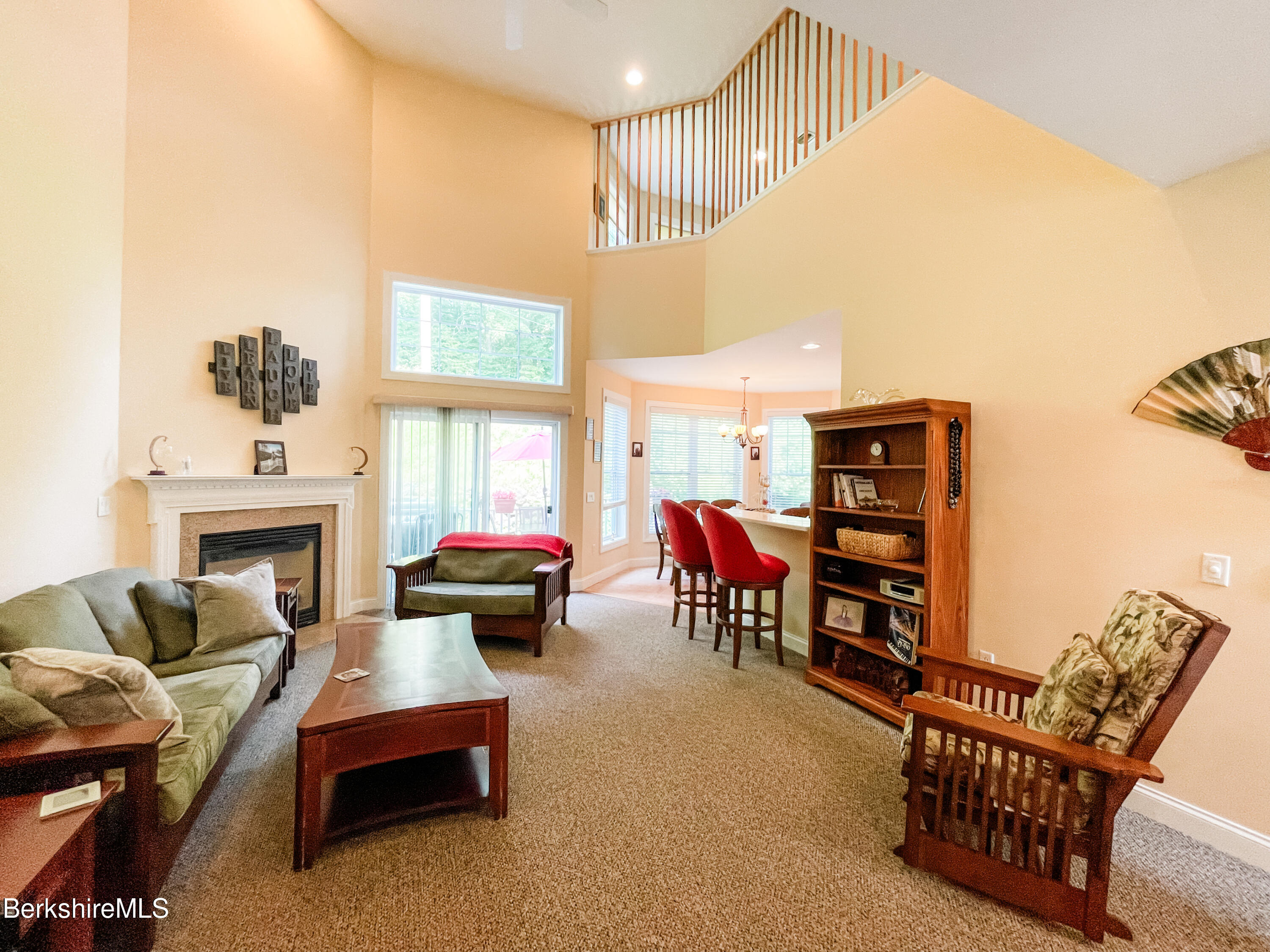 22 Alpine Trail Pittsfield, MA 01201 - Photo 8 of 35 a living room with furniture a fireplace and a floor to ceiling window