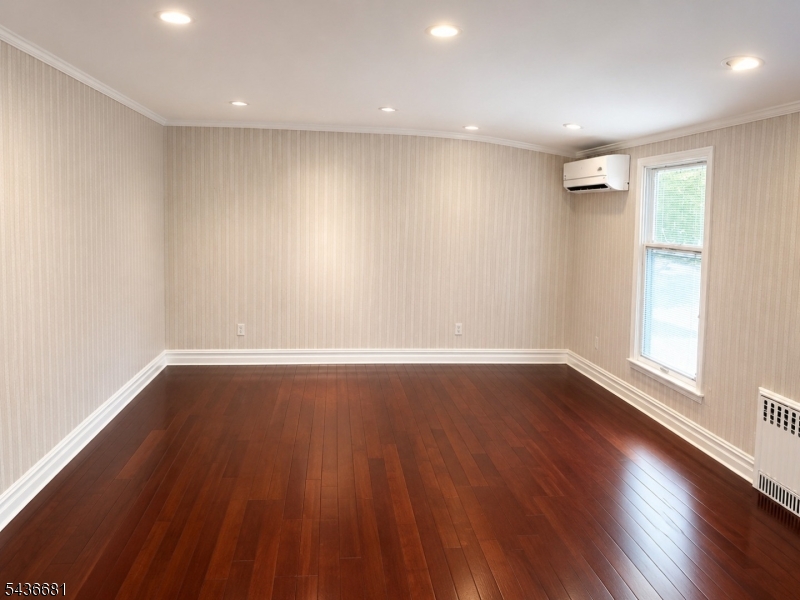 178 East Lindsley Road, Unit 2 Cedar Grove, NJ 07009 - Photo 8 of 28 an empty room with wooden floor and windows