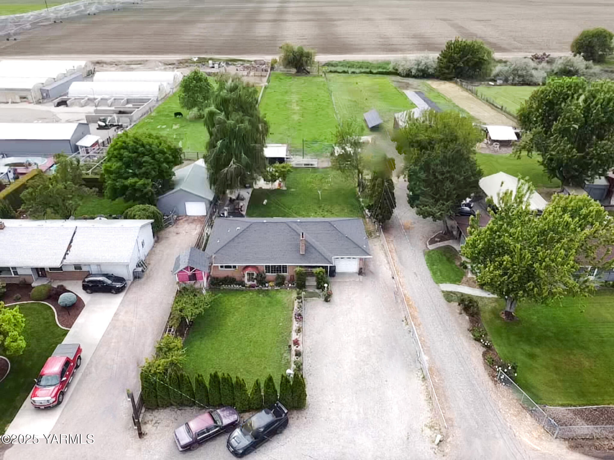 an aerial view of a house with a garden and pool