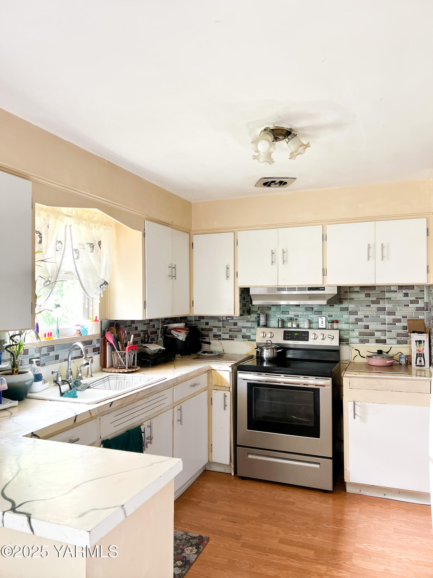 1341 Cemetery Road Sunnyside, WA 98944 - Photo 10 of 18 a kitchen with stainless steel appliances kitchen island granite countertop a sink and cabinets