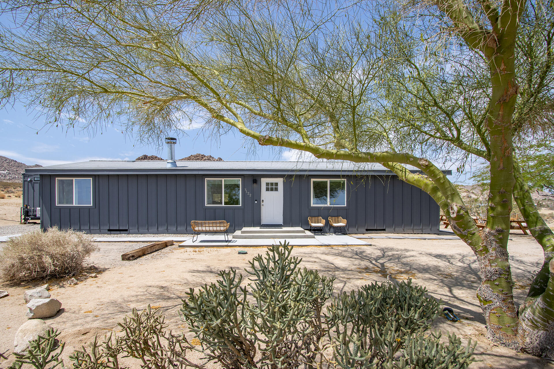 7122 Sunkist Road Joshua Tree, CA 92252 - Photo 2 of 61 a front view of a house with a yard covered with snow in front of house