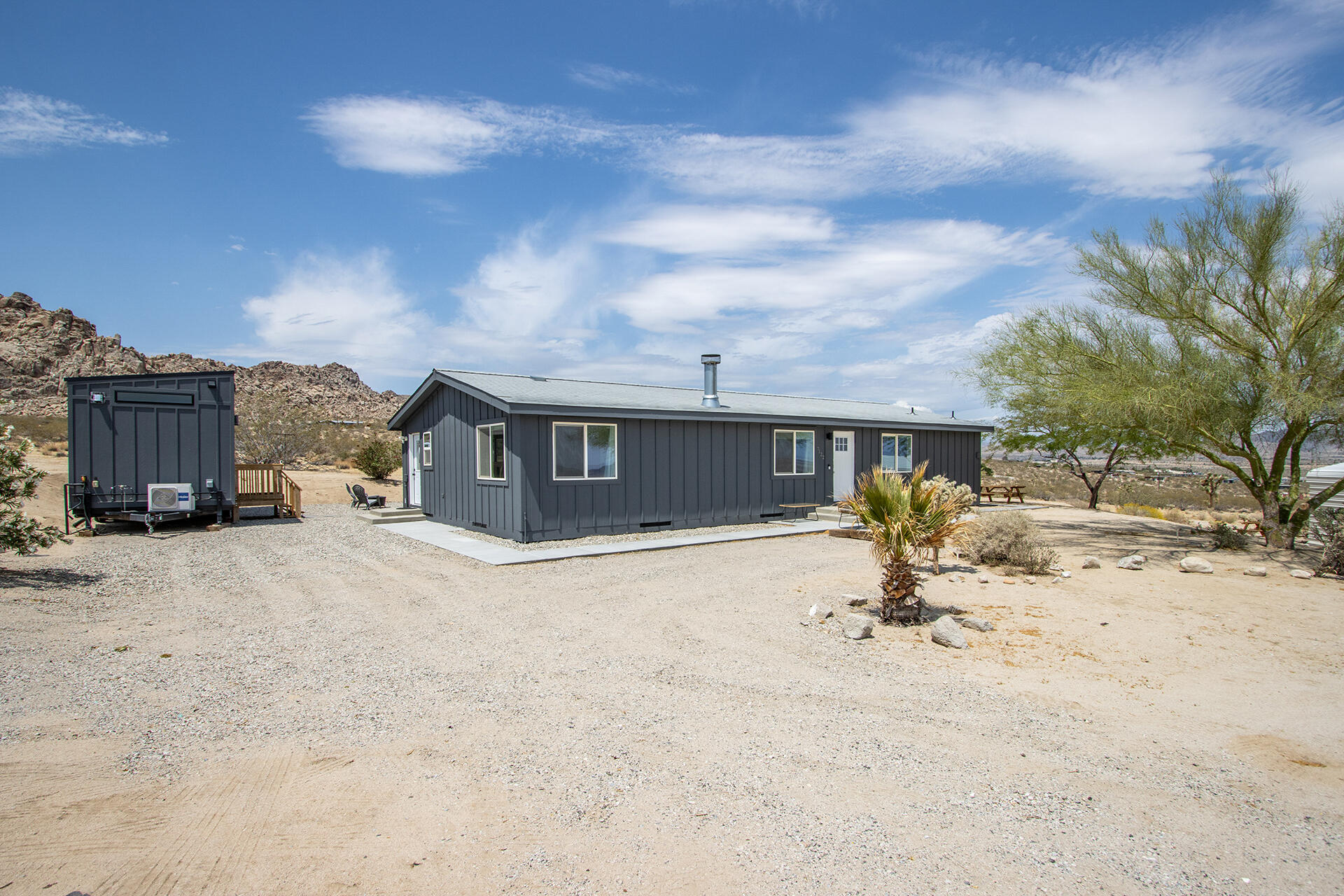 7122 Sunkist Road Joshua Tree, CA 92252 - Photo 21 of 61 a view of a house with a yard and garage