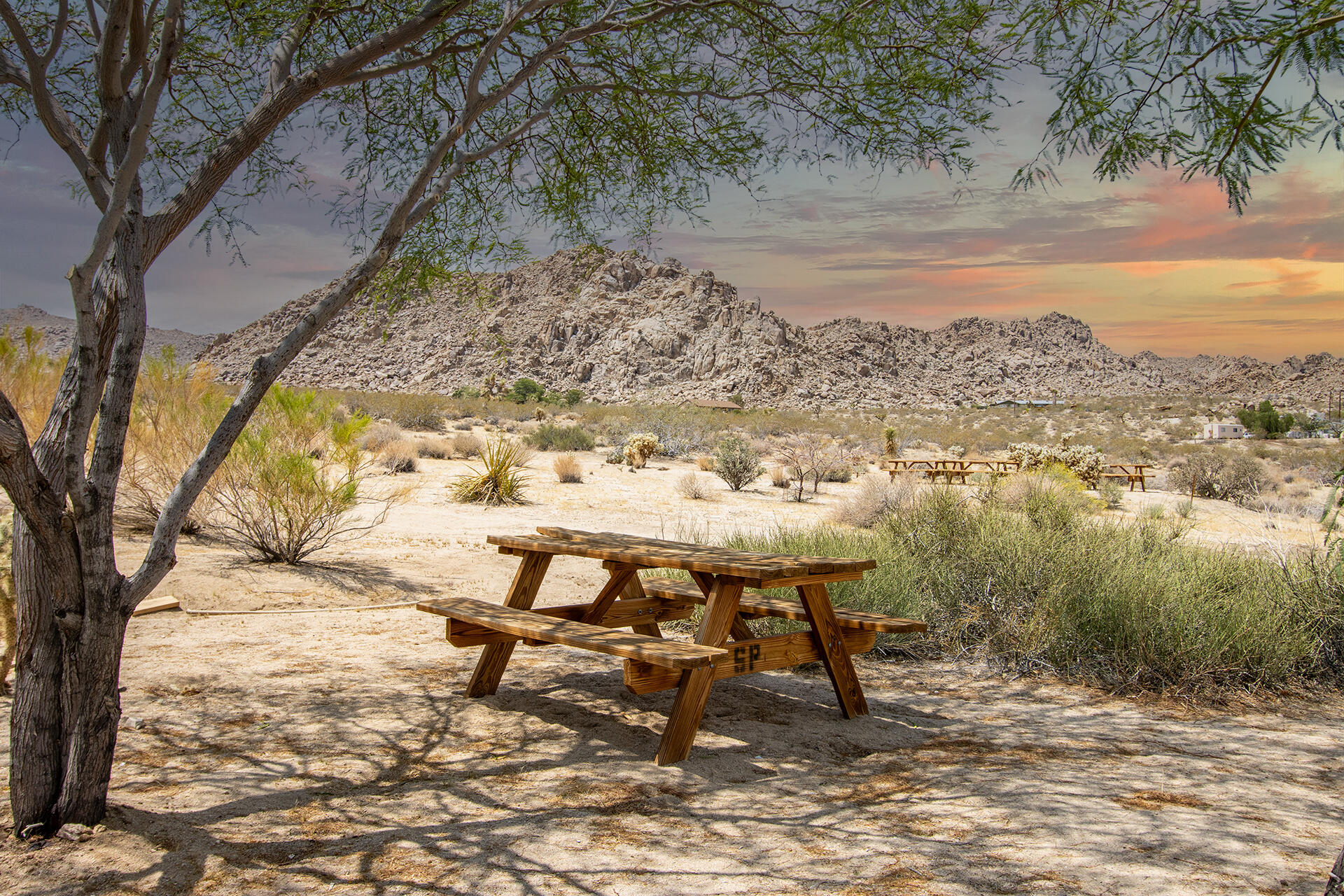 7122 Sunkist Road Joshua Tree, CA 92252 - Photo 25 of 61 a view of a lake with a table and chairs