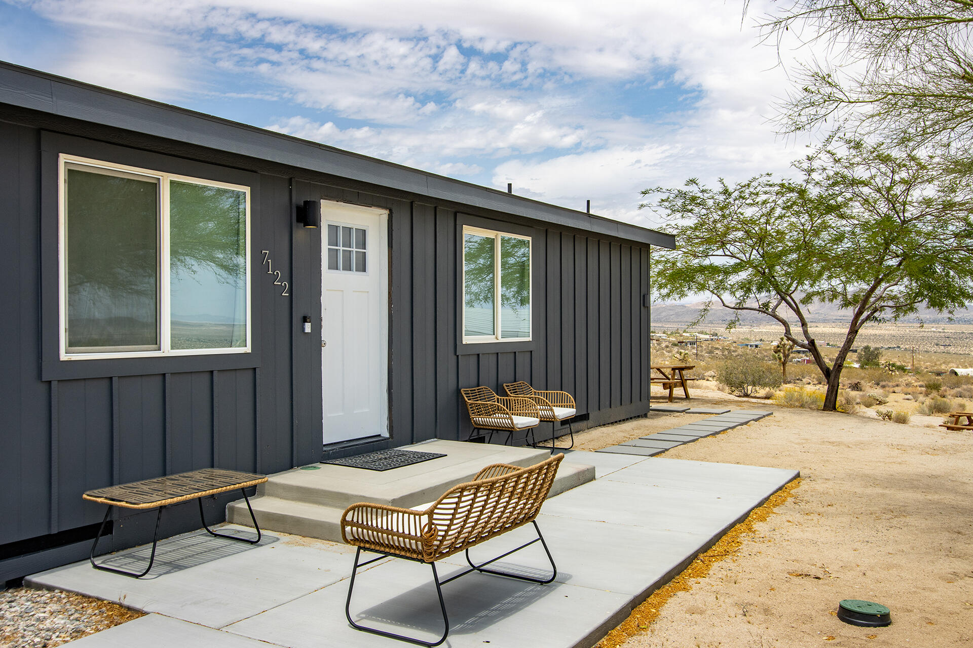 7122 Sunkist Road Joshua Tree, CA 92252 - Photo 27 of 61 a backyard of a house with table and chairs