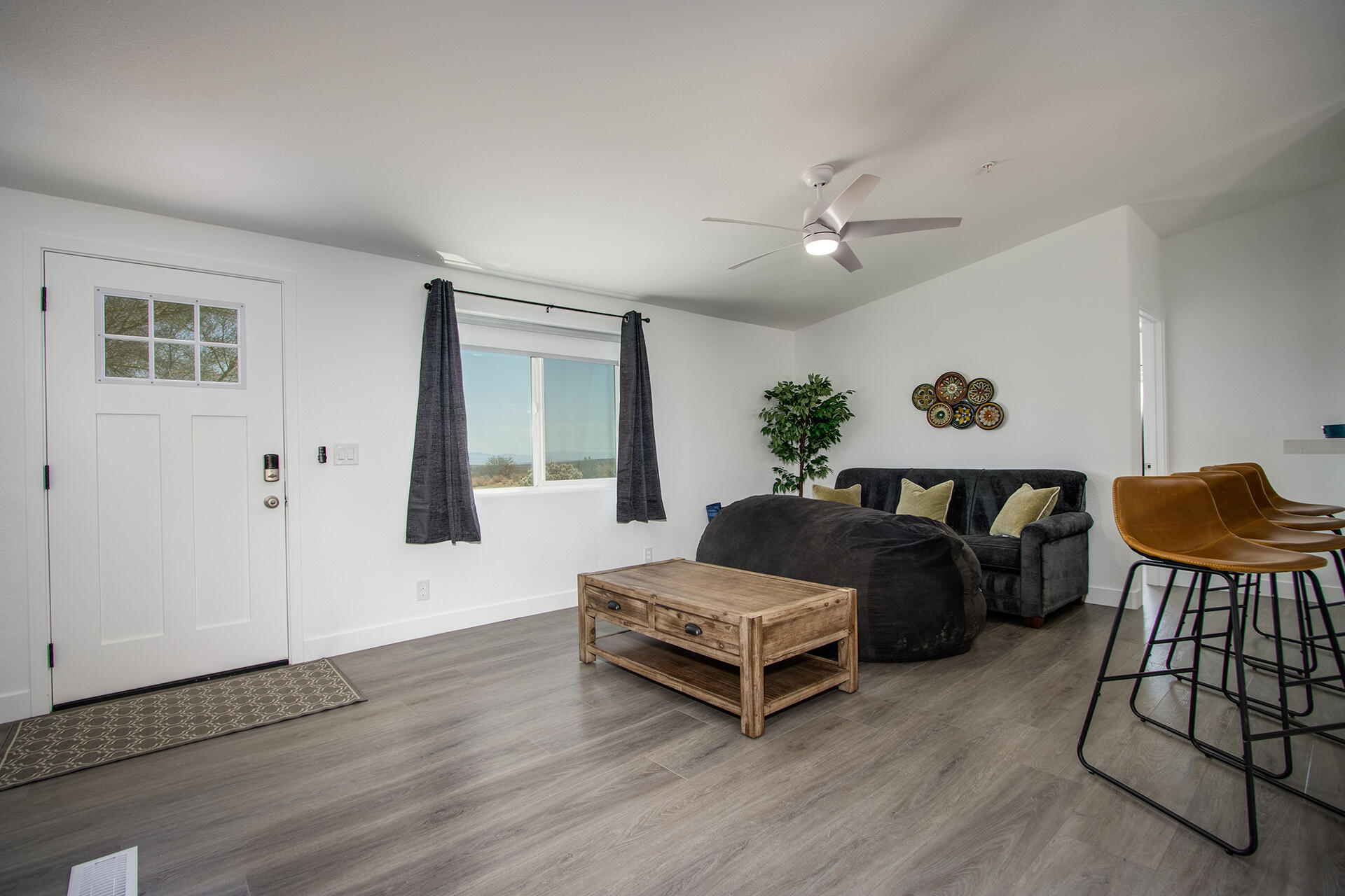 7122 Sunkist Road Joshua Tree, CA 92252 - Photo 29 of 61 a living room with furniture and wooden floor